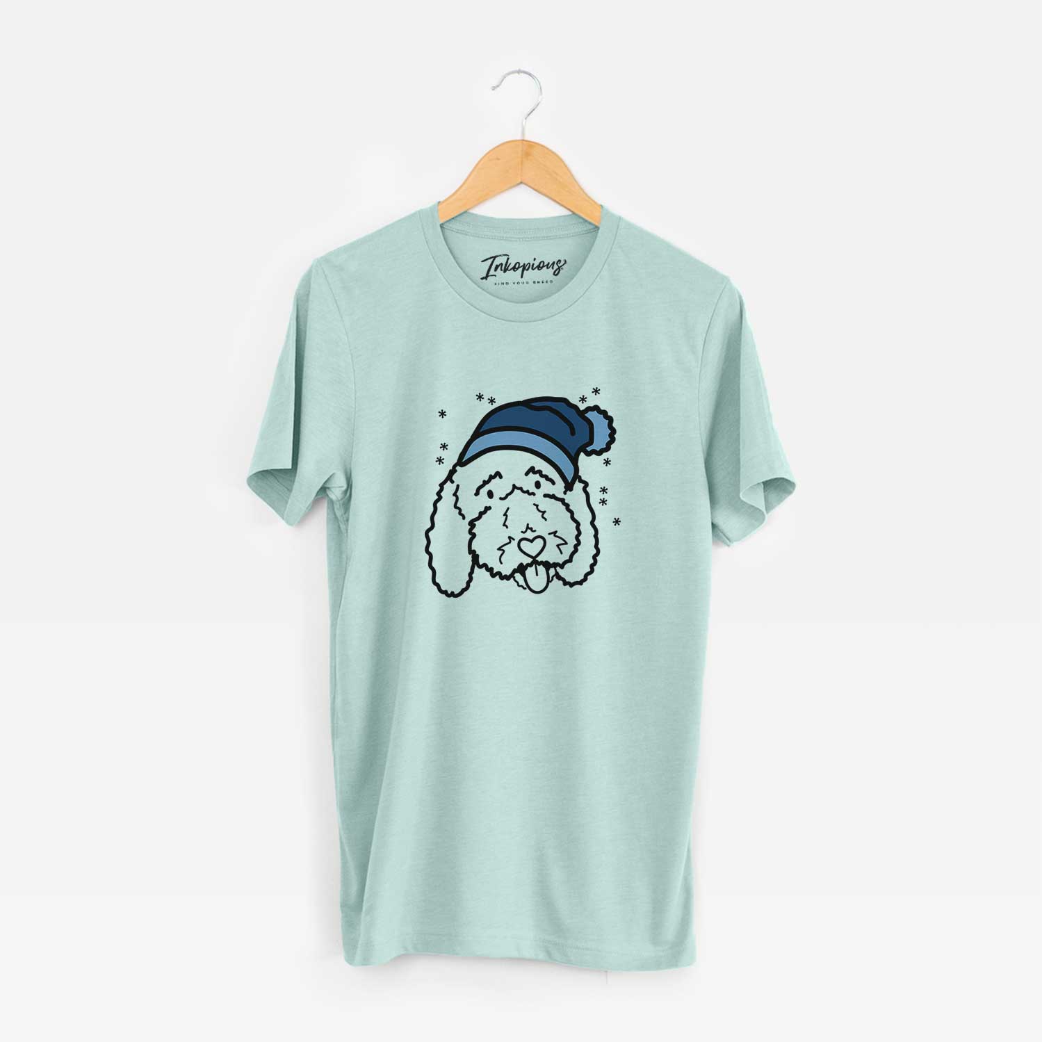 Minimalist line drawing of Ruby the Bernedoodle wearing a winter beanie on a Heather Sage Unisex crewneck
