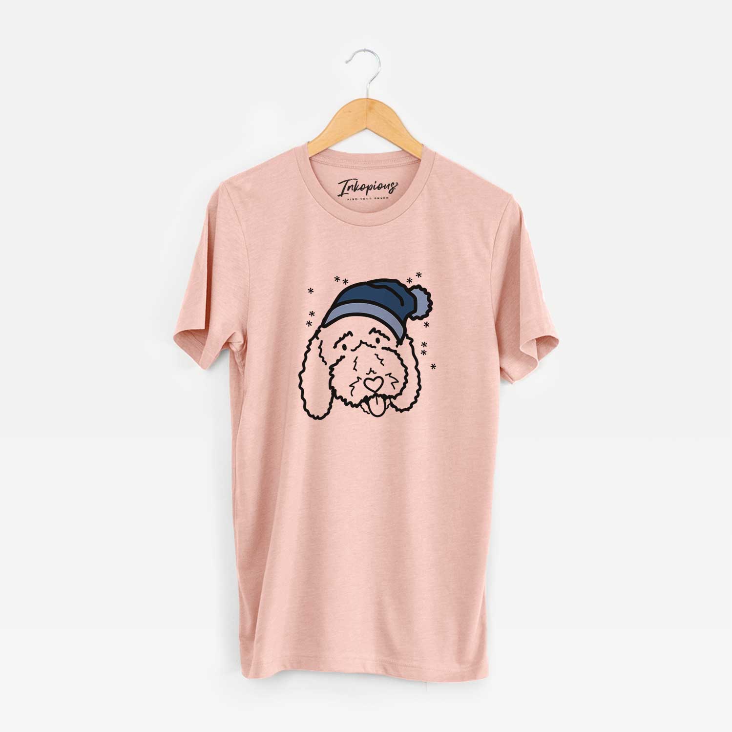Minimalist line drawing of Ruby the Bernedoodle wearing a winter beanie on a Peach Unisex crewneck