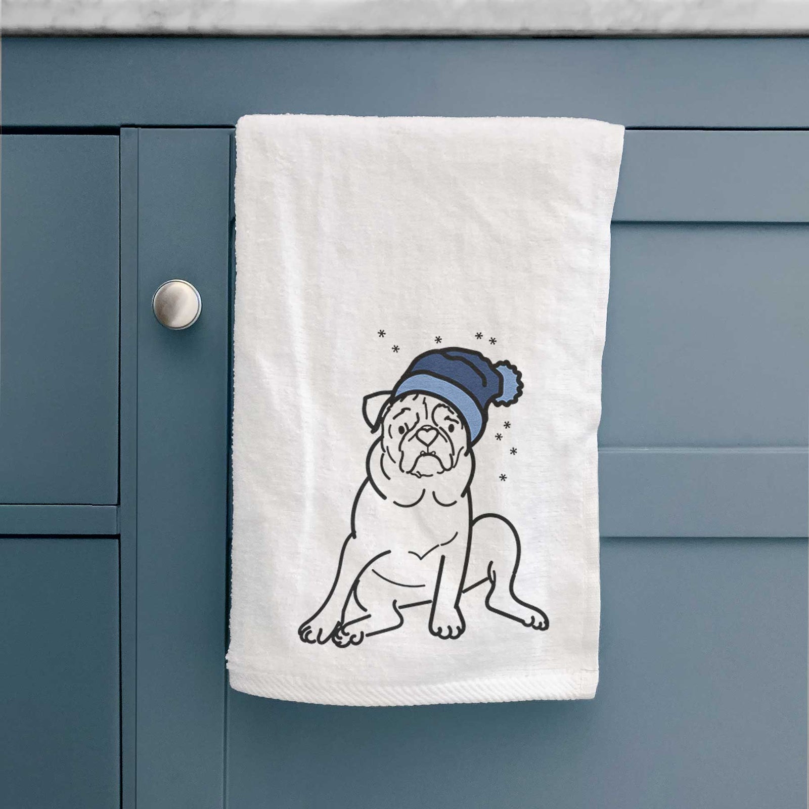 Minimalist line drawing of Rudy the Pug wearing a winter beanie on a decorative hand towel