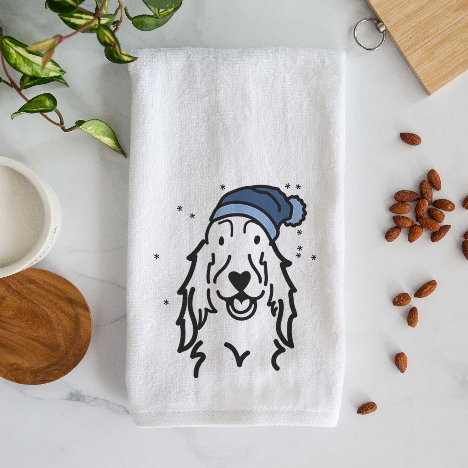 Minimalist line drawing of a Setter wearing a winter beanie on a decorative hand towel