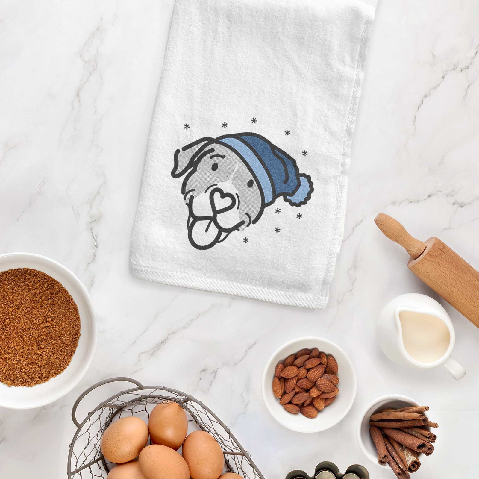 Minimalist line drawing of Shadow the Pitbull Mix wearing a winter beanie on a decorative hand towel