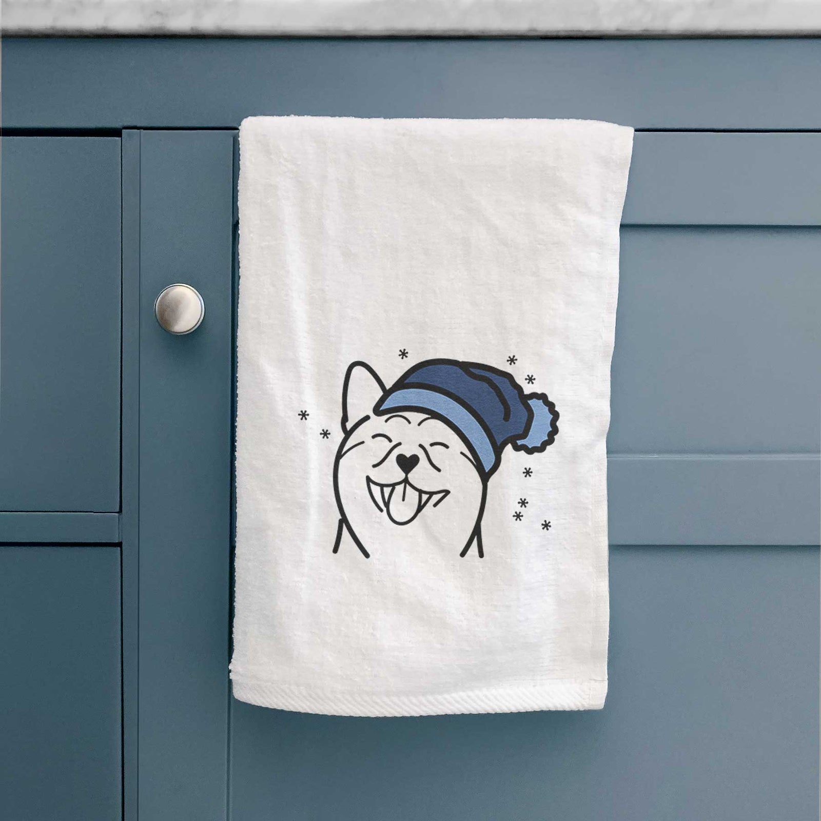 Minimalist line drawing of a Shiba Inu wearing a winter beanie on a decorative hand towel