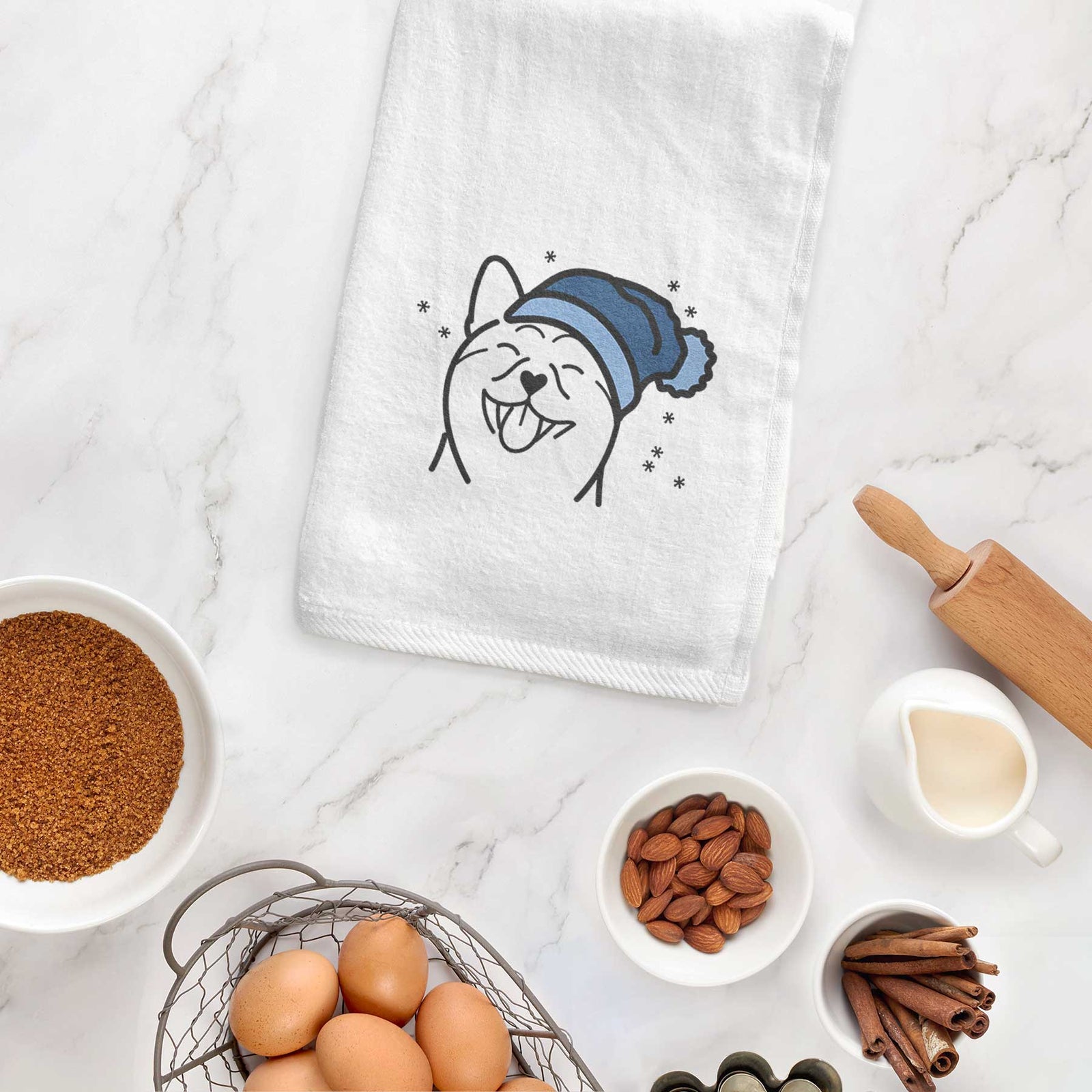 Minimalist line drawing of a Shiba Inu wearing a winter beanie on a decorative hand towel