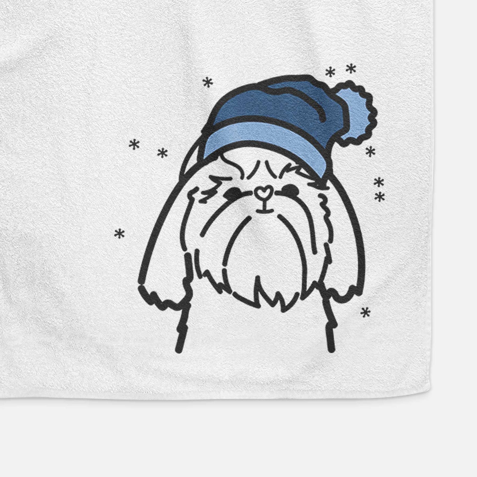 Minimalist line drawing of a Shih Tzu wearing a winter beanie on a decorative hand towel