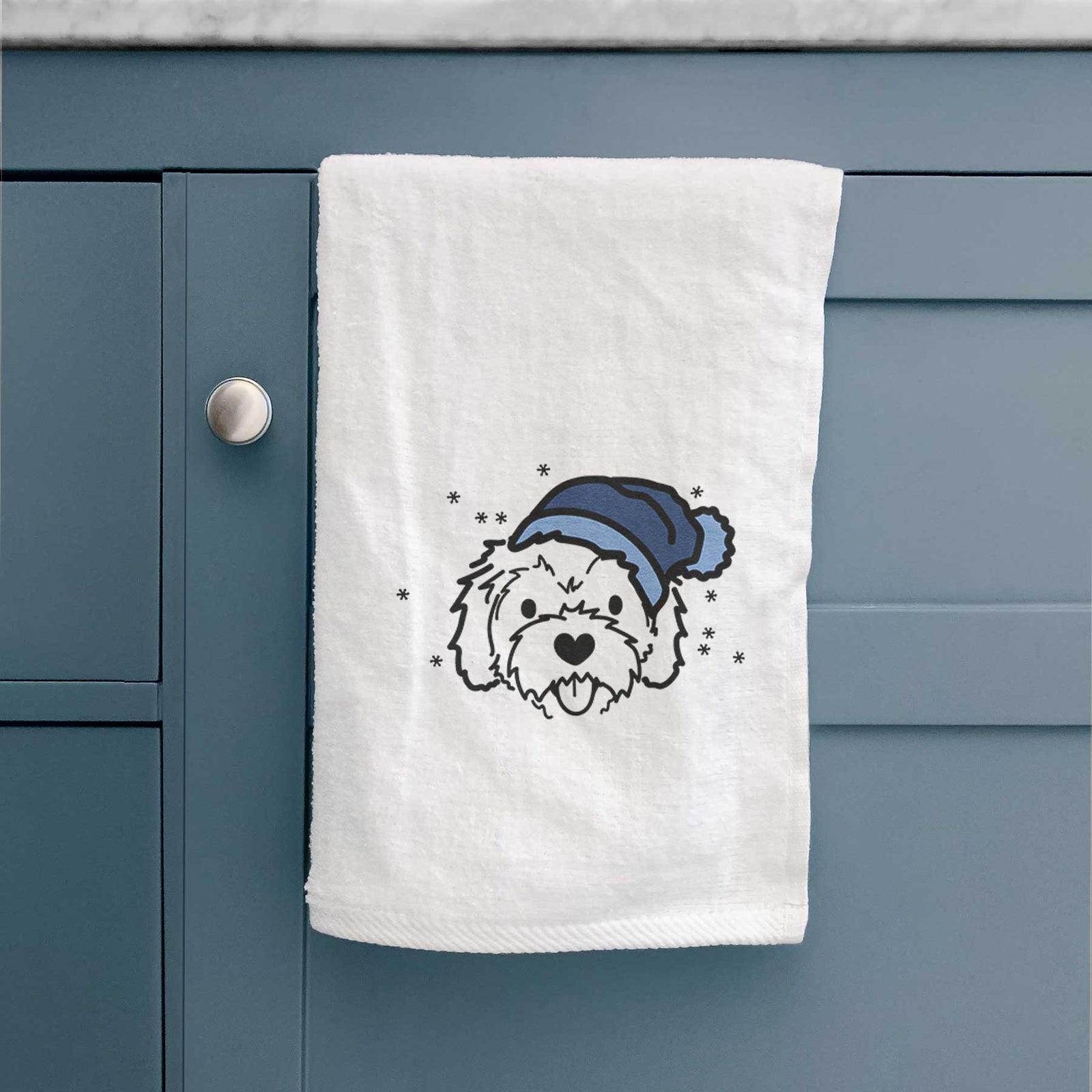 Minimalist line drawing of Sprinkles the Cockapoo wearing a winter beanie on a decorative hand towel