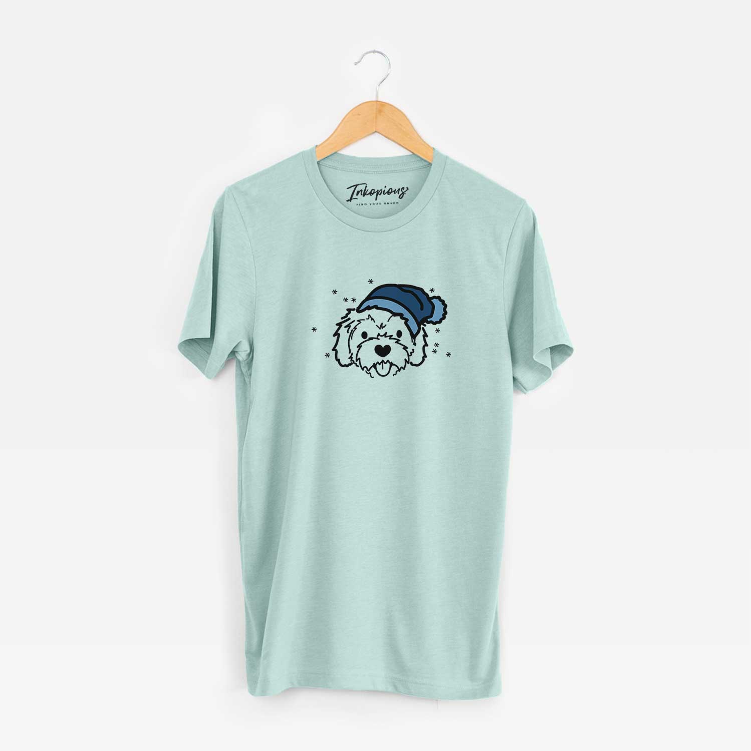 Minimalist line drawing of Sprinkles the Cockapoo wearing a winter beanie on a Heather Sage Unisex crewneck