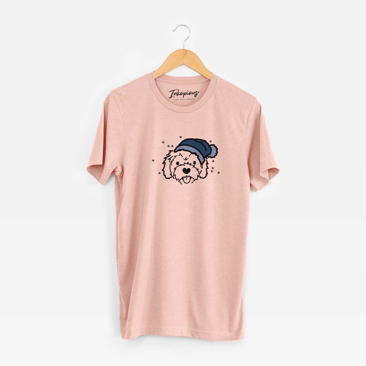 Minimalist line drawing of Sprinkles the Cockapoo wearing a winter beanie on a Peach Unisex crewneck
