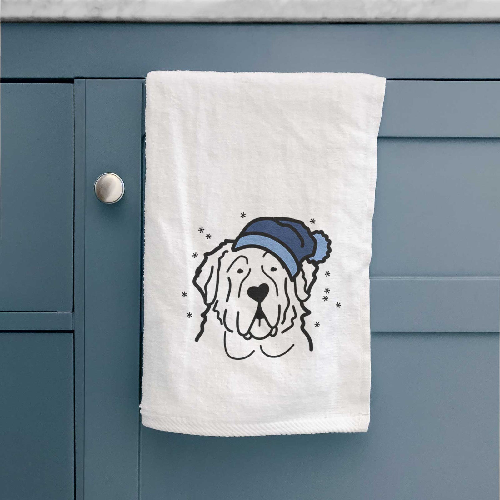 Minimalist line drawing of a Saint Bernard wearing a winter beanie on a decorative hand towel