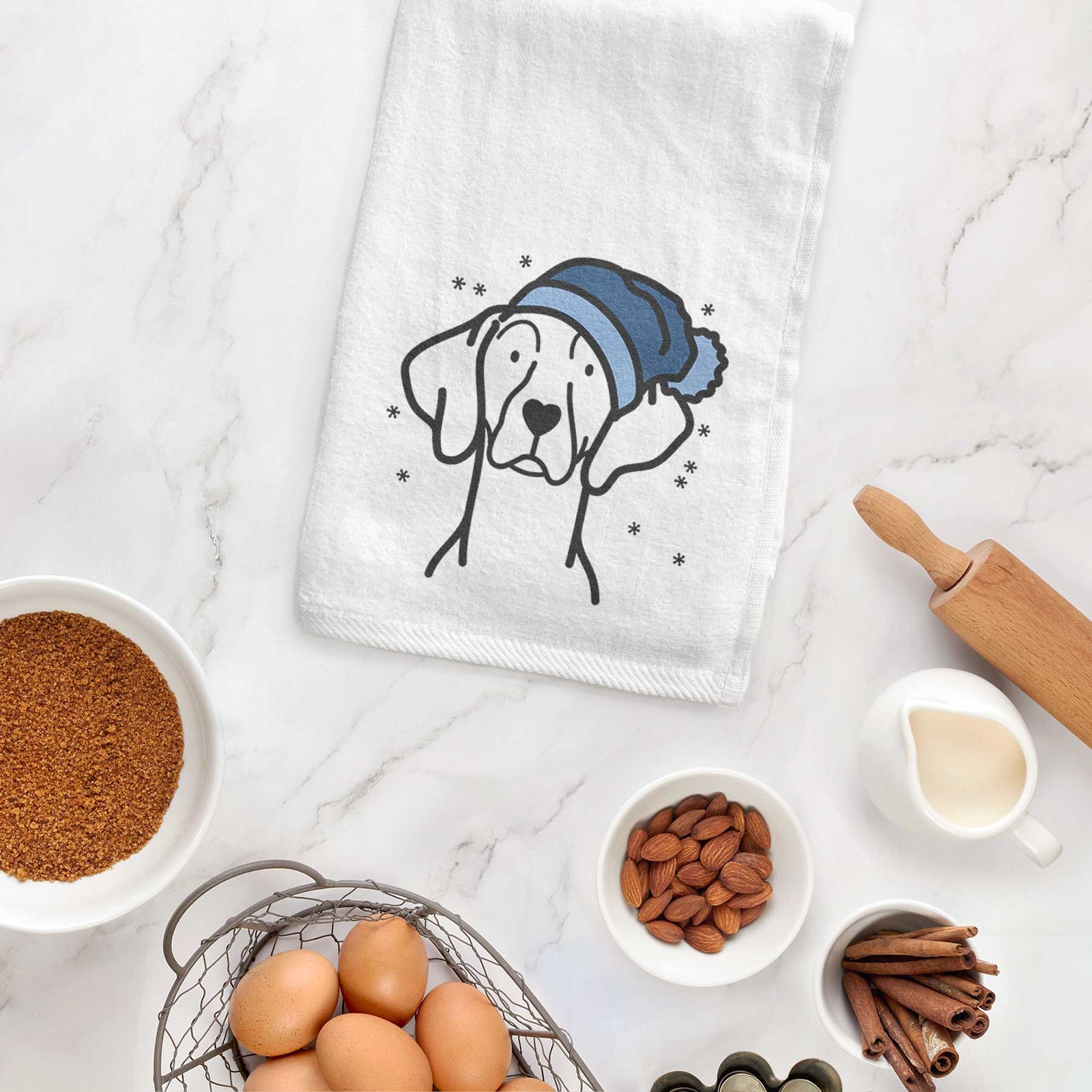 Minimalist line drawing of a Weimaraner wearing a winter beanie on a decorative hand towel