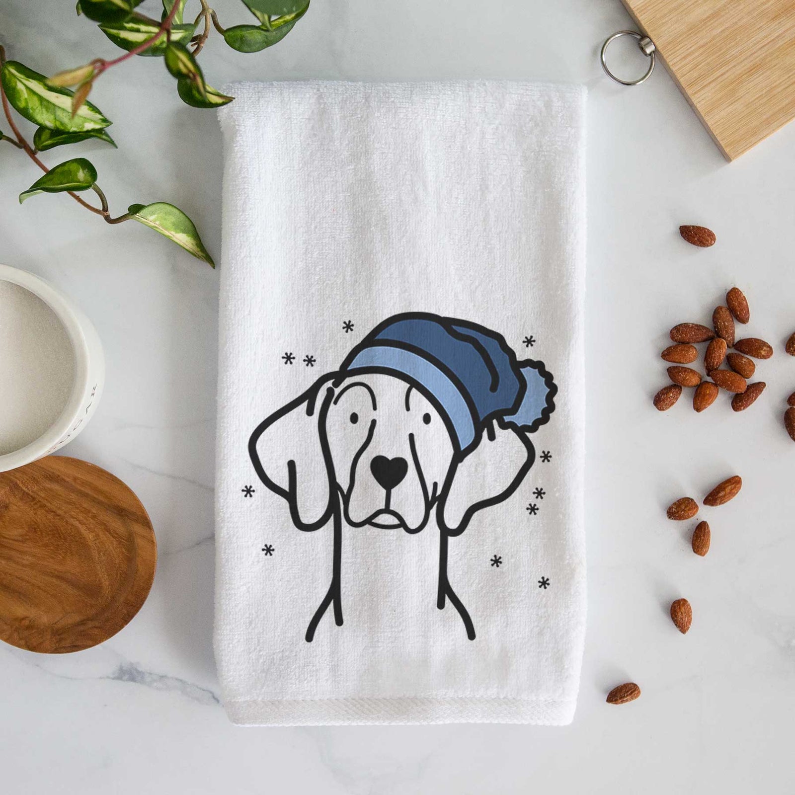 Minimalist line drawing of a Weimaraner wearing a winter beanie on a decorative hand towel