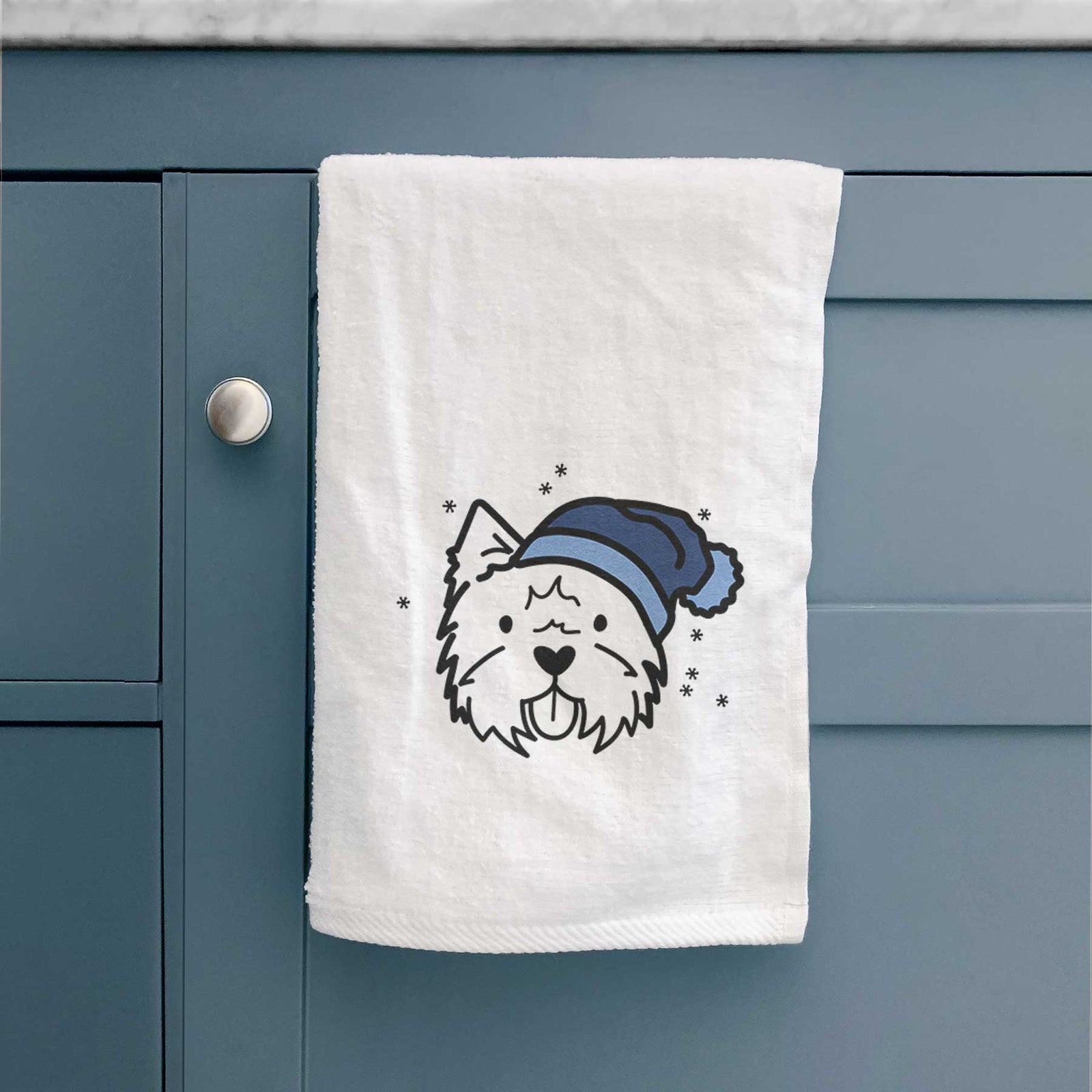 Minimalist line drawing of a West Highland Terrier wearing a winter beanie on a decorative hand towel