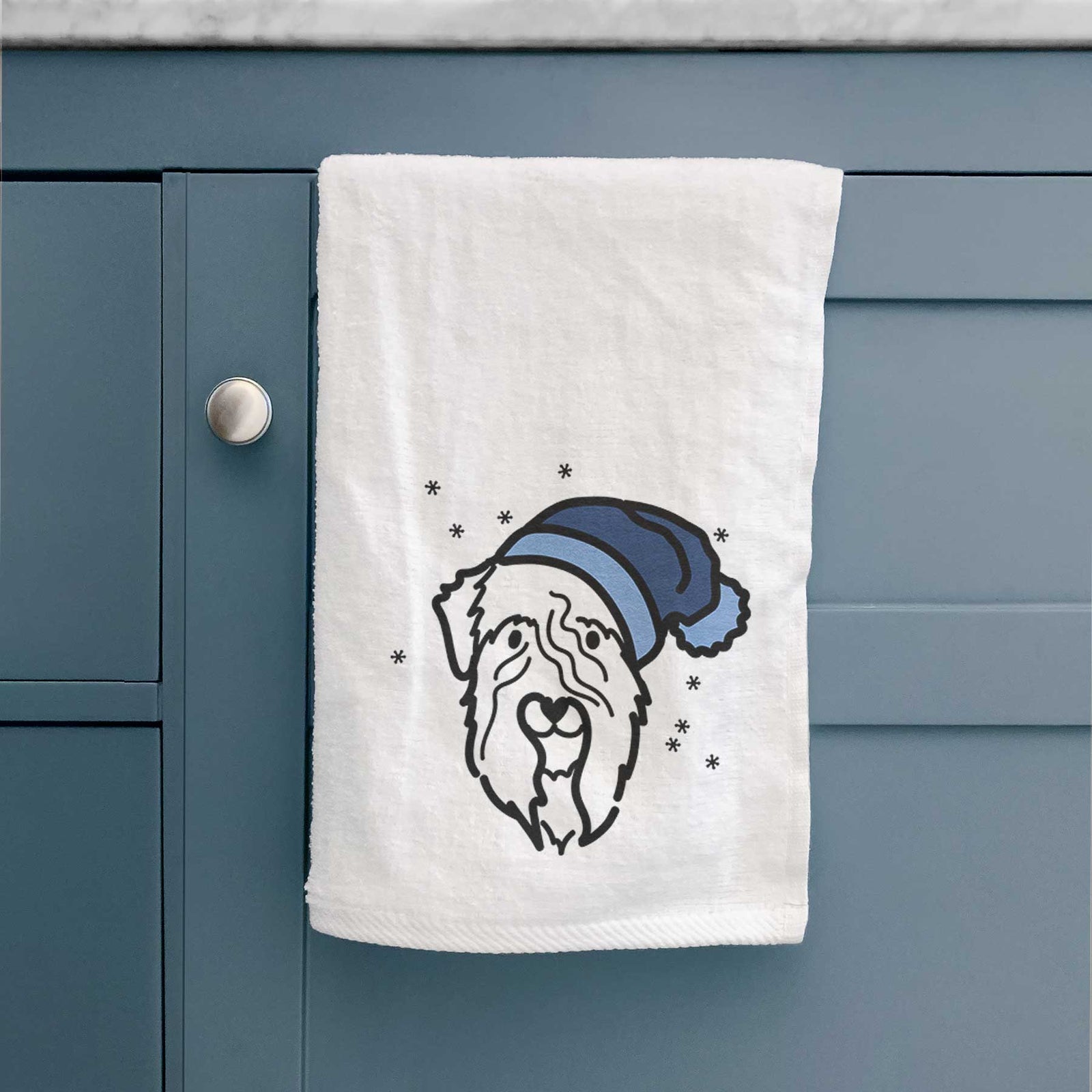 Minimalist line drawing of a Soft Coated Wheaten Terrier wearing a winter beanie on a decorative hand towel