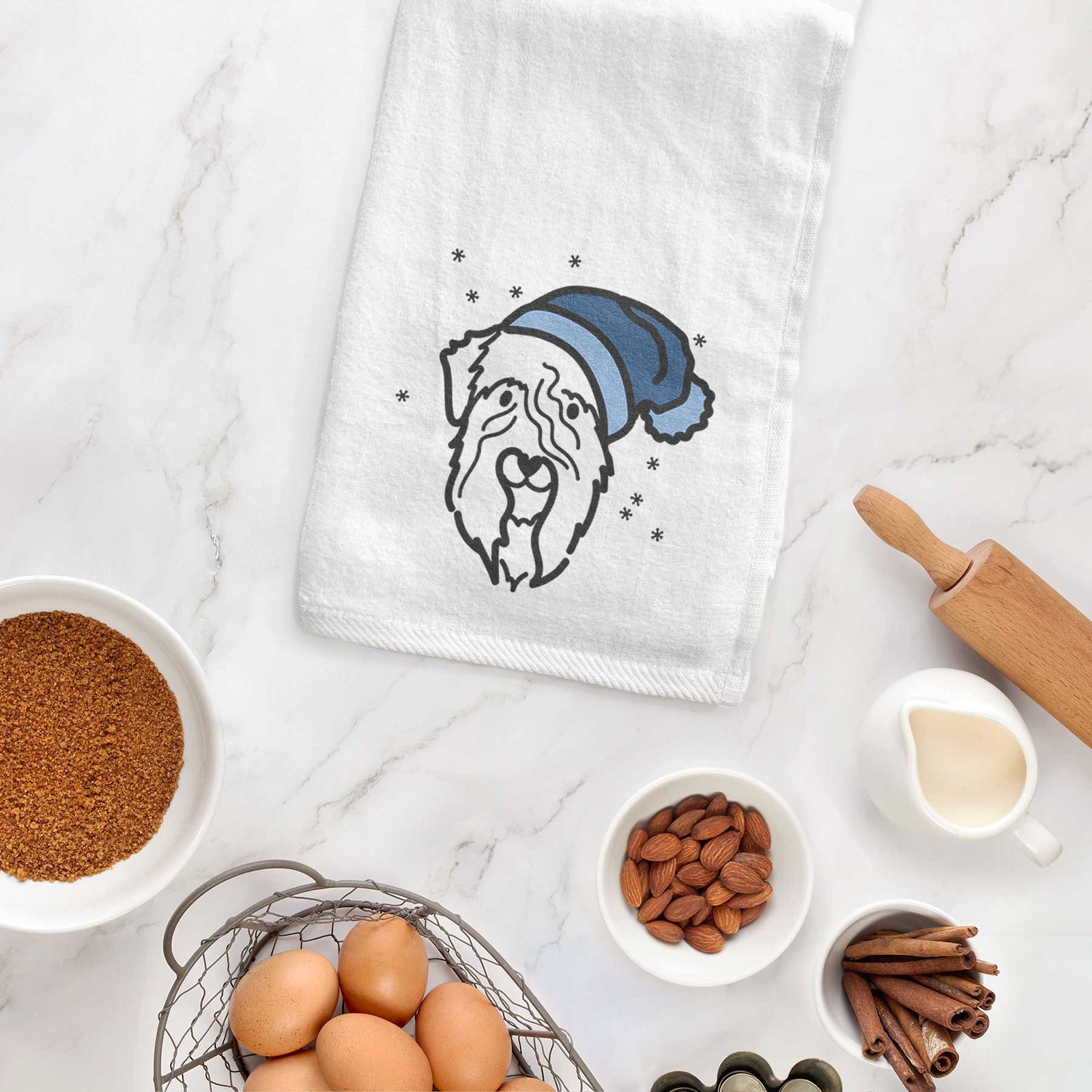Minimalist line drawing of a Soft Coated Wheaten Terrier wearing a winter beanie on a decorative hand towel