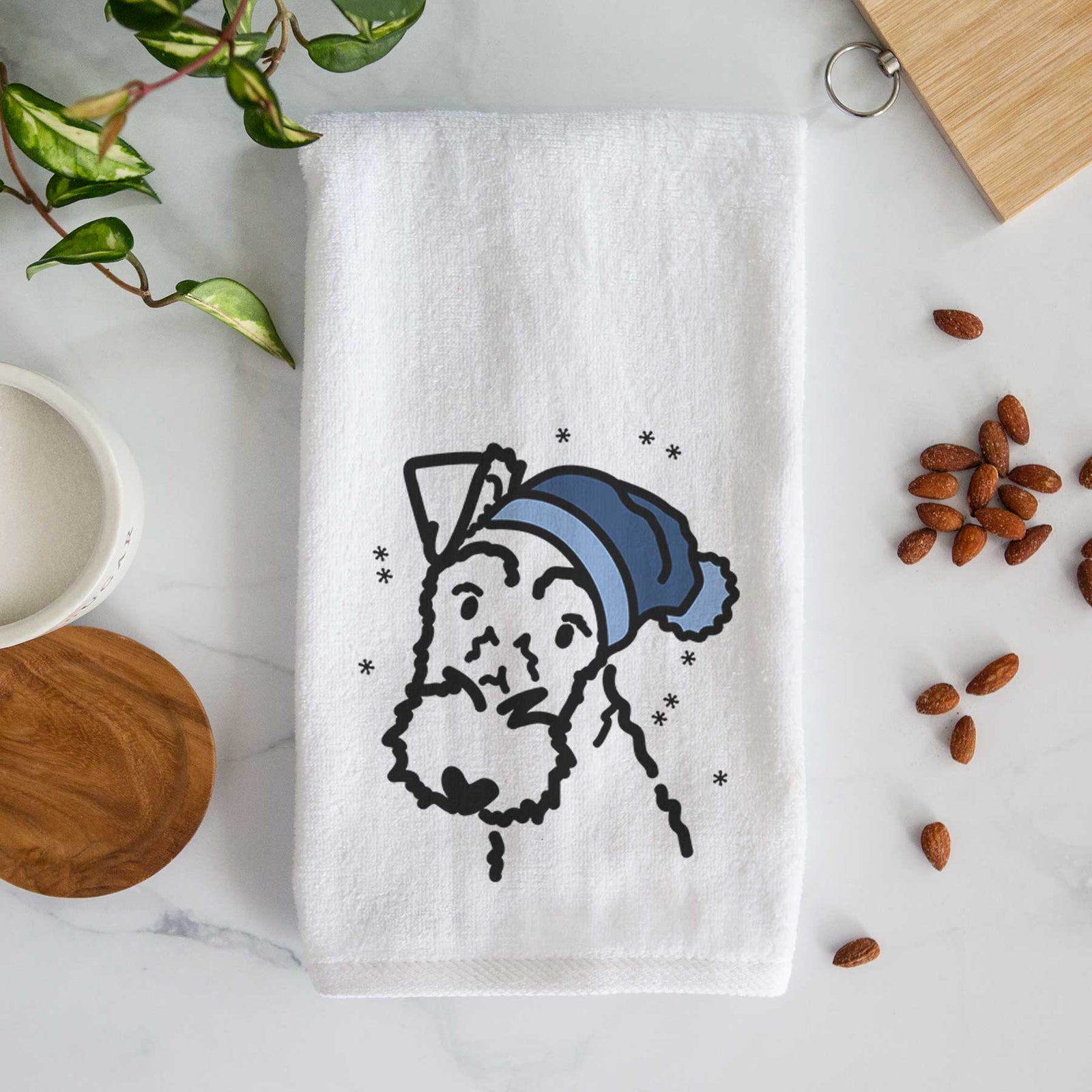 Minimalist line drawing of a Wire Fox Terrier wearing a winter beanie on a decorative hand towel