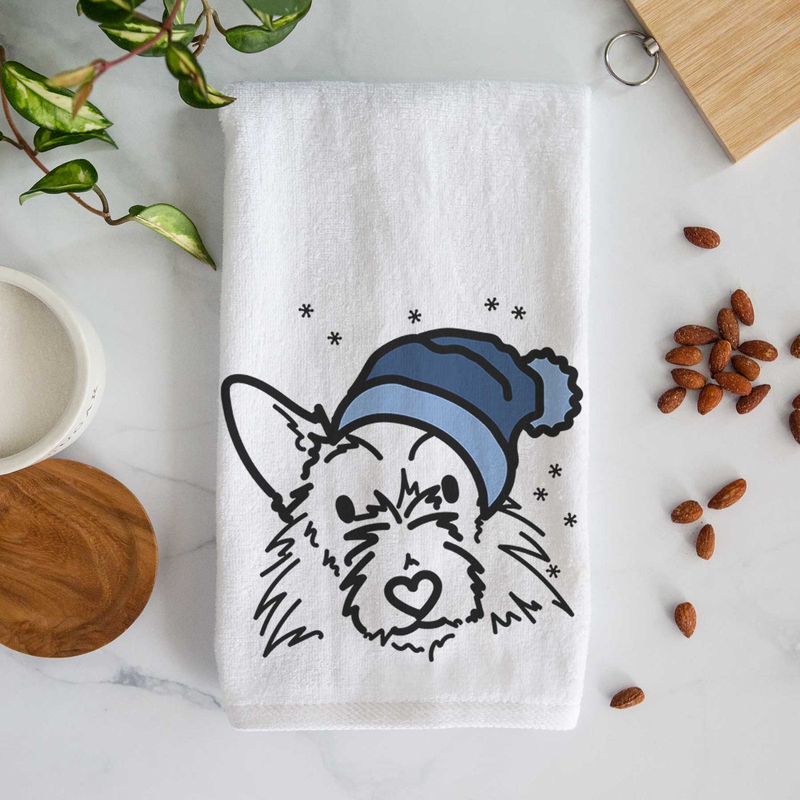 Minimalist line drawing of Ziggy the Terrier Mix wearing a winter beanie on a decorative hand towel