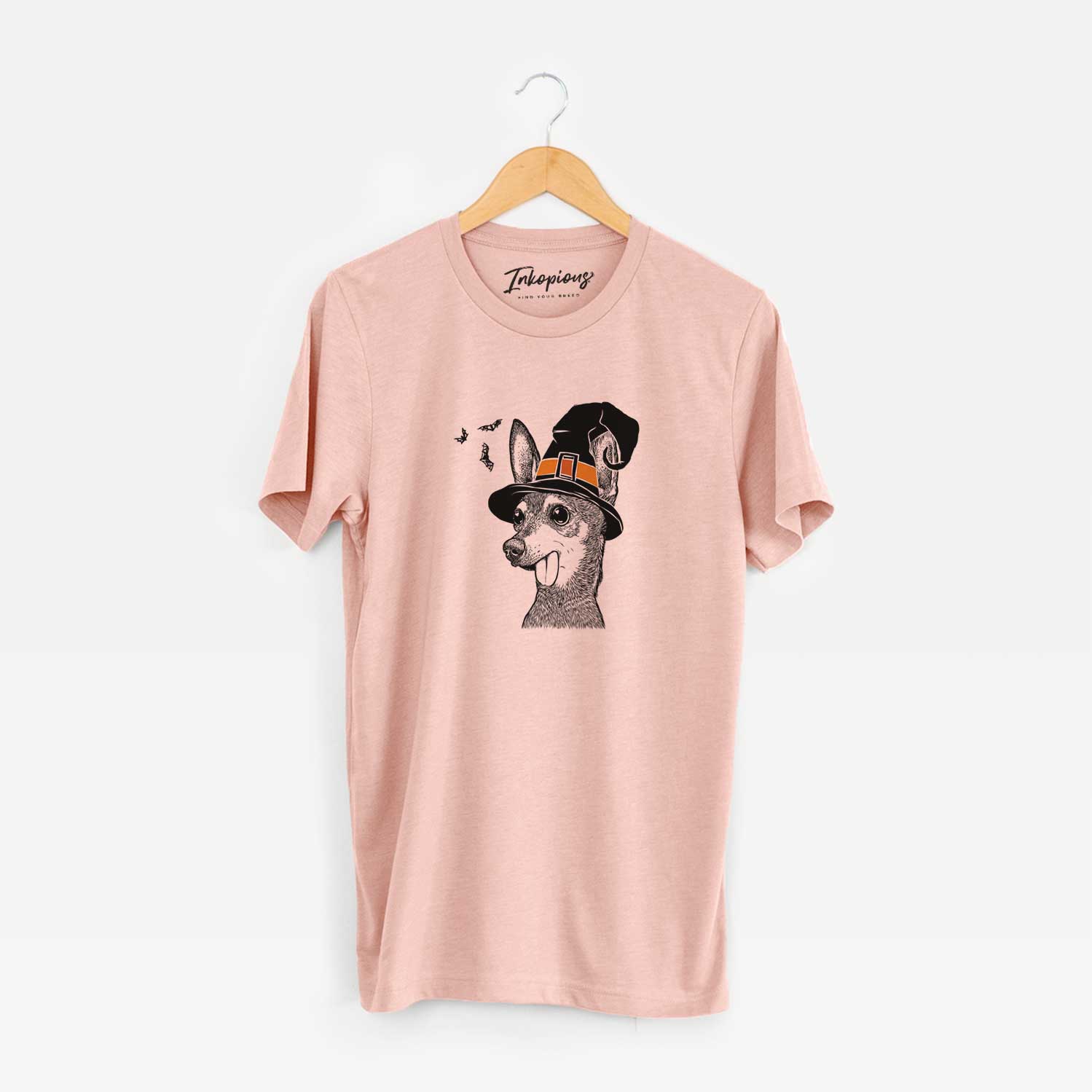 Hand-drawn sketch of Aaron the Chihuahua wearing a witch hat on a Peach Unisex crewneck