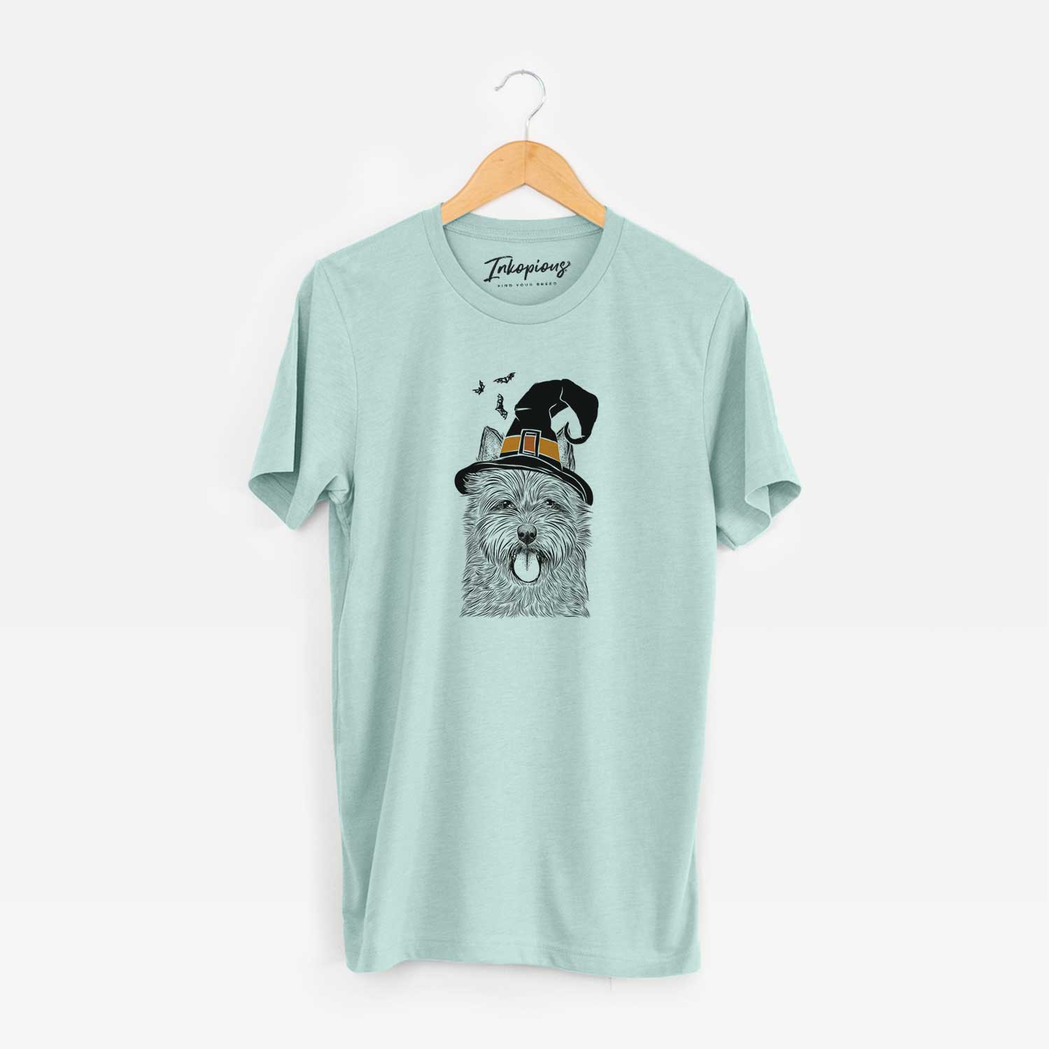 Hand-drawn sketch of Alfie the Norwich Terrier wearing a witch hat on a Heather Sage Unisex crewneck