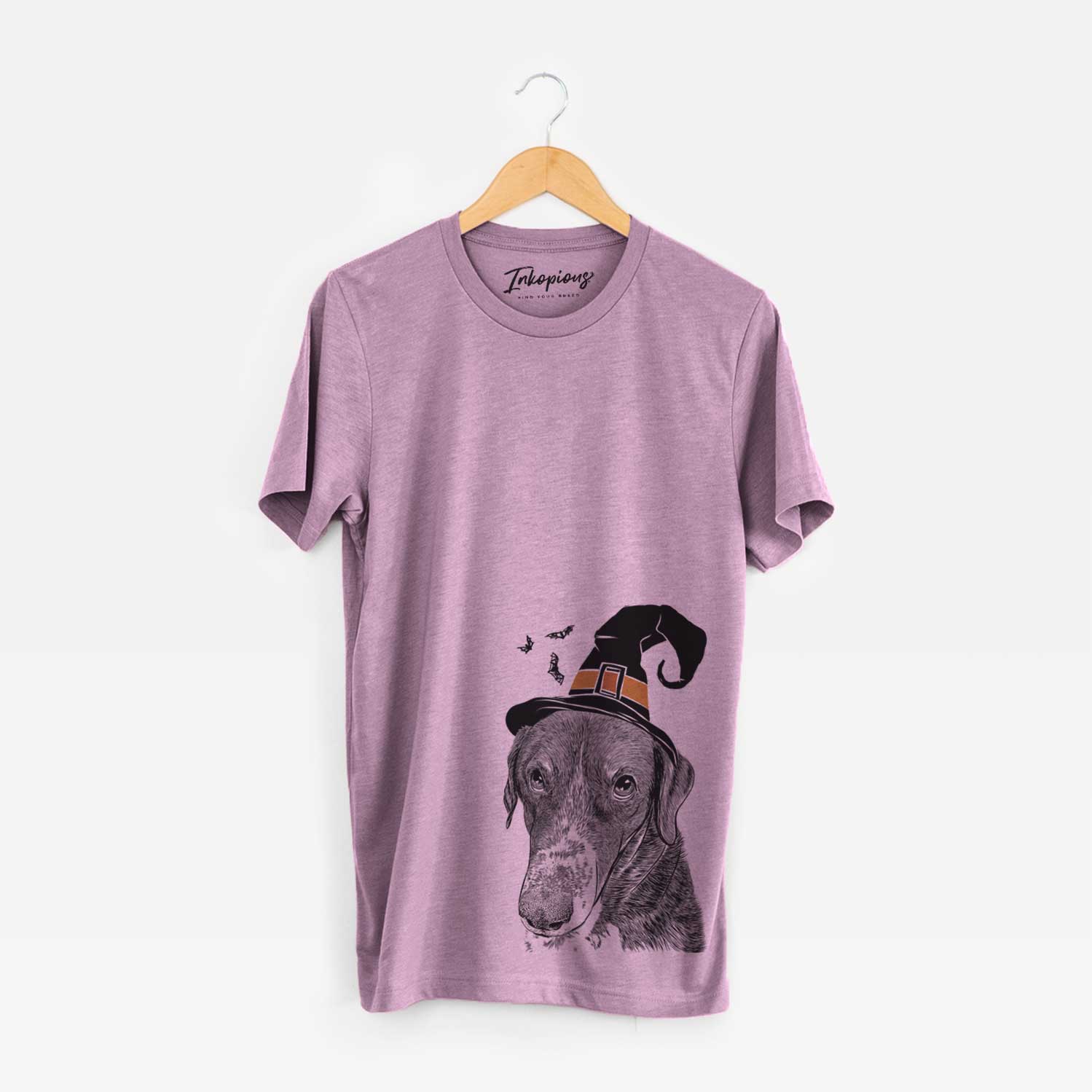 Hand-drawn sketch of Angel Orion the Mixed Breed wearing a witch hat on an Orchid Unisex crewneck