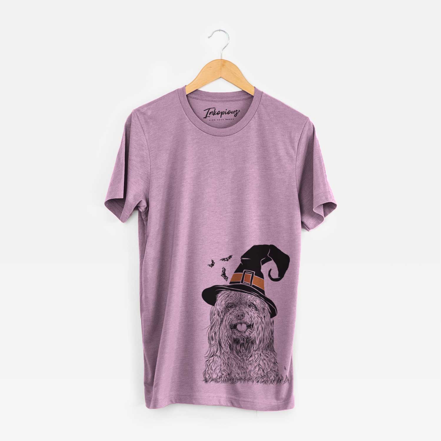 Hand-drawn sketch of Annie the Mixed Breed wearing a witch hat on an Orchid Unisex crewneck