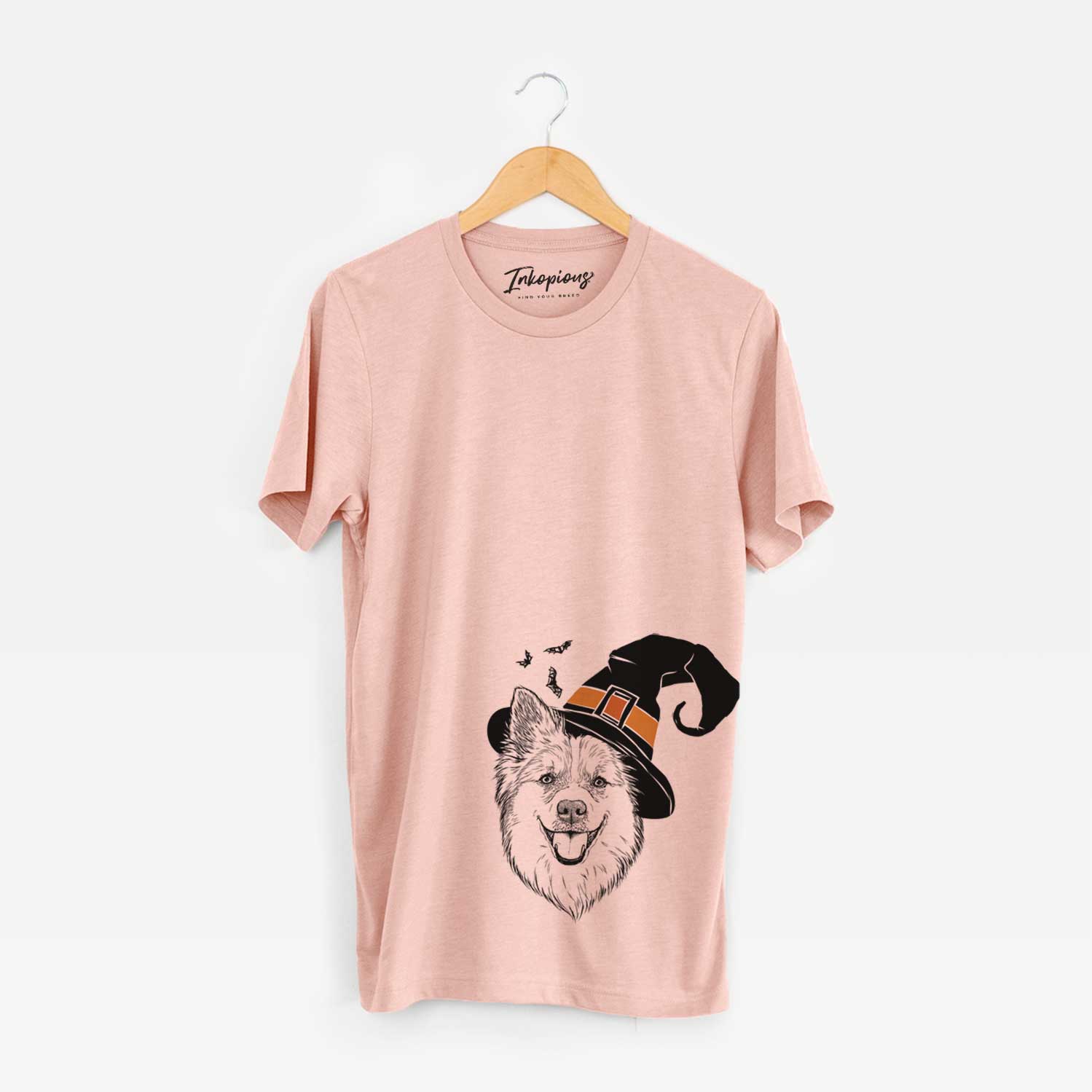 Hand-drawn sketch of Ari the Icelandic Sheepdog wearing a witch hat on a Peach Unisex crewneck