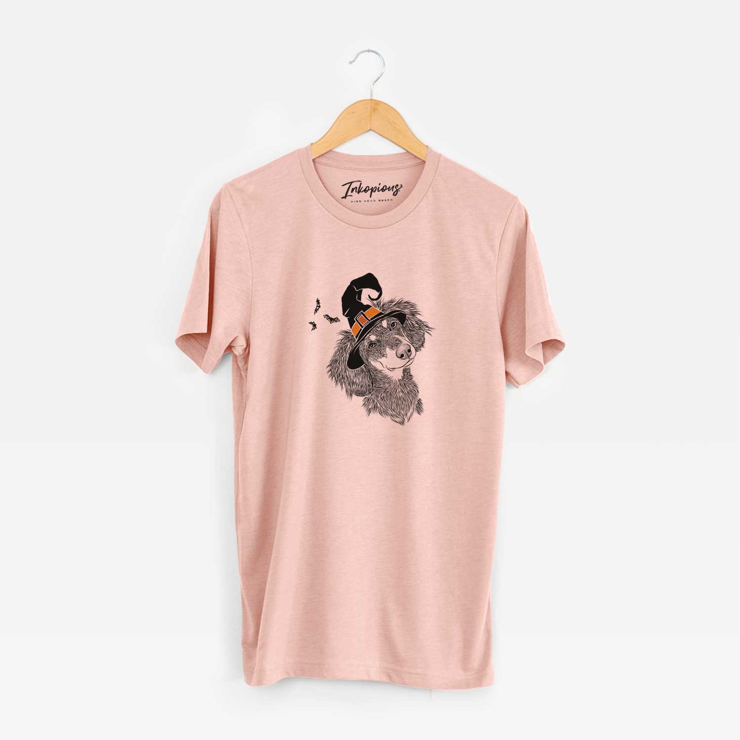 Hand-drawn sketch of Bailey the Long Haired Dachshund wearing a witch hat on a Peach Unisex crewneck