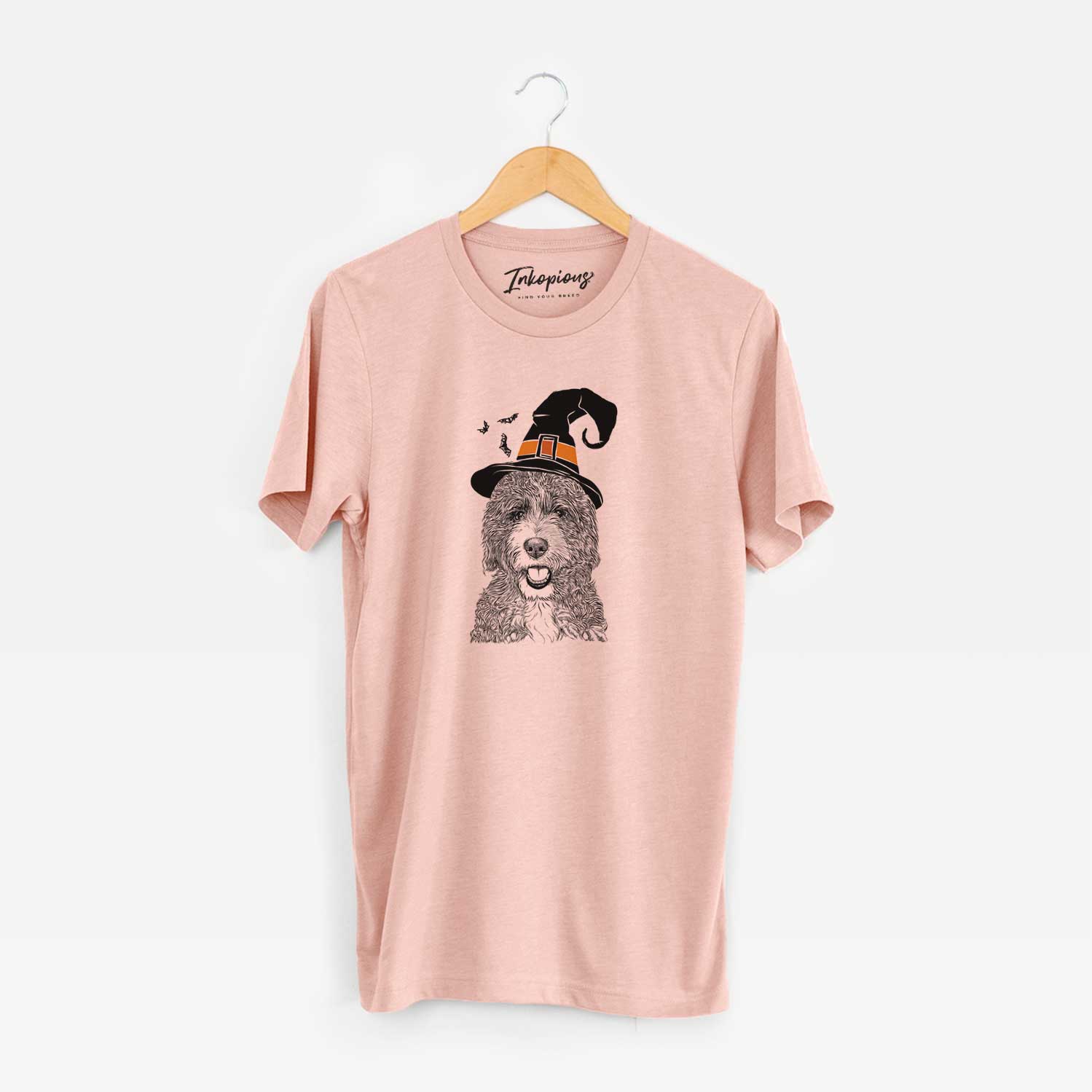 Hand-drawn sketch of Bash the Bernedoodle wearing a witch hat on a Peach Unisex crewneck