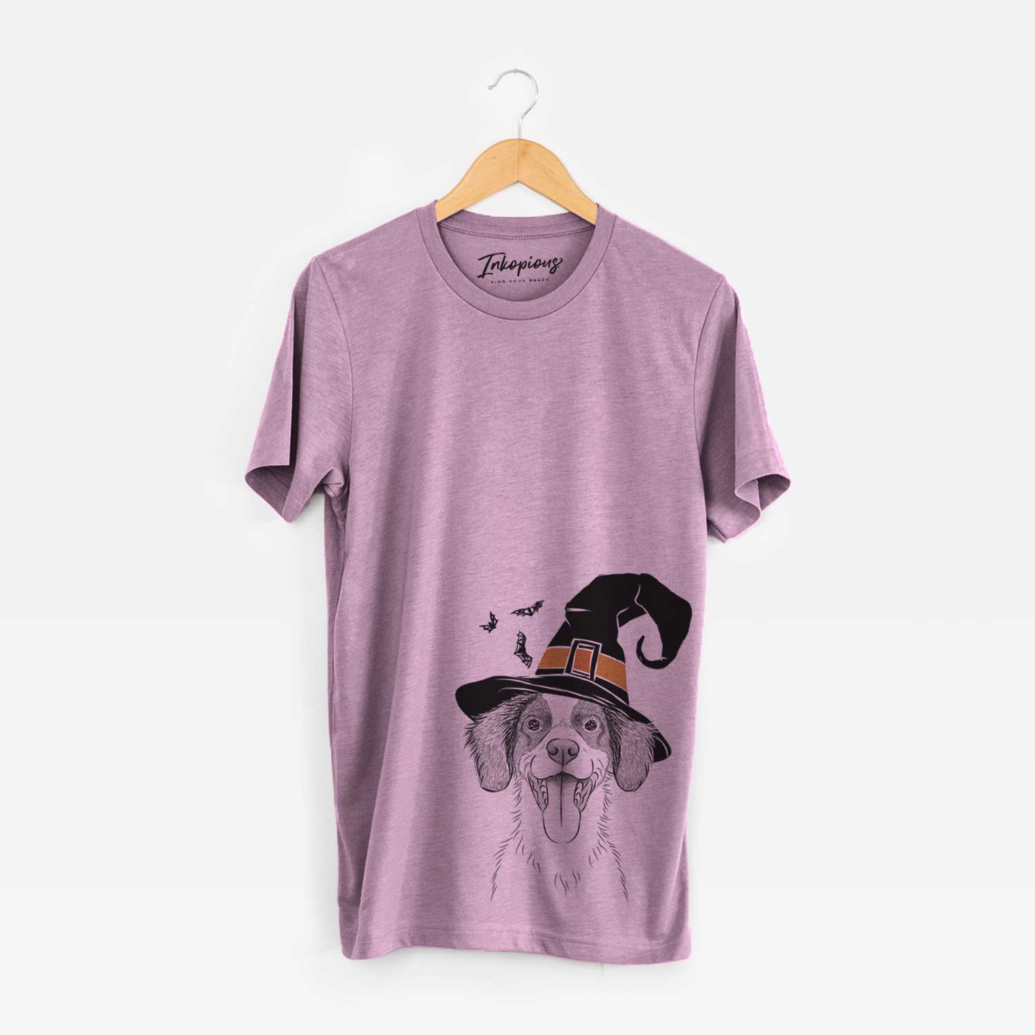 Hand-drawn sketch of Birdie the Brittany wearing a witch hat on an Orchid Unisex crewneck