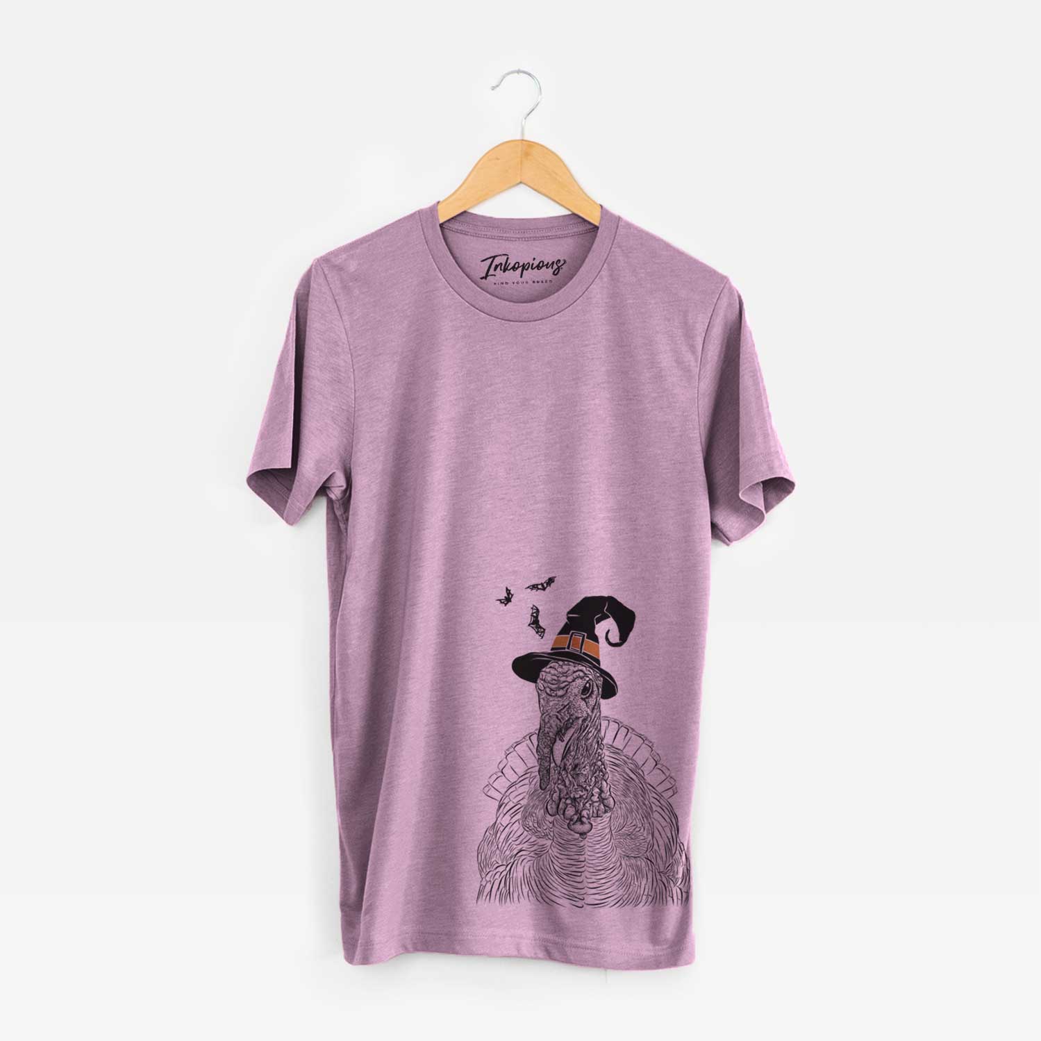 Hand-drawn sketch of Brady the Turkey wearing a witch hat on an Orchid Unisex crewneck
