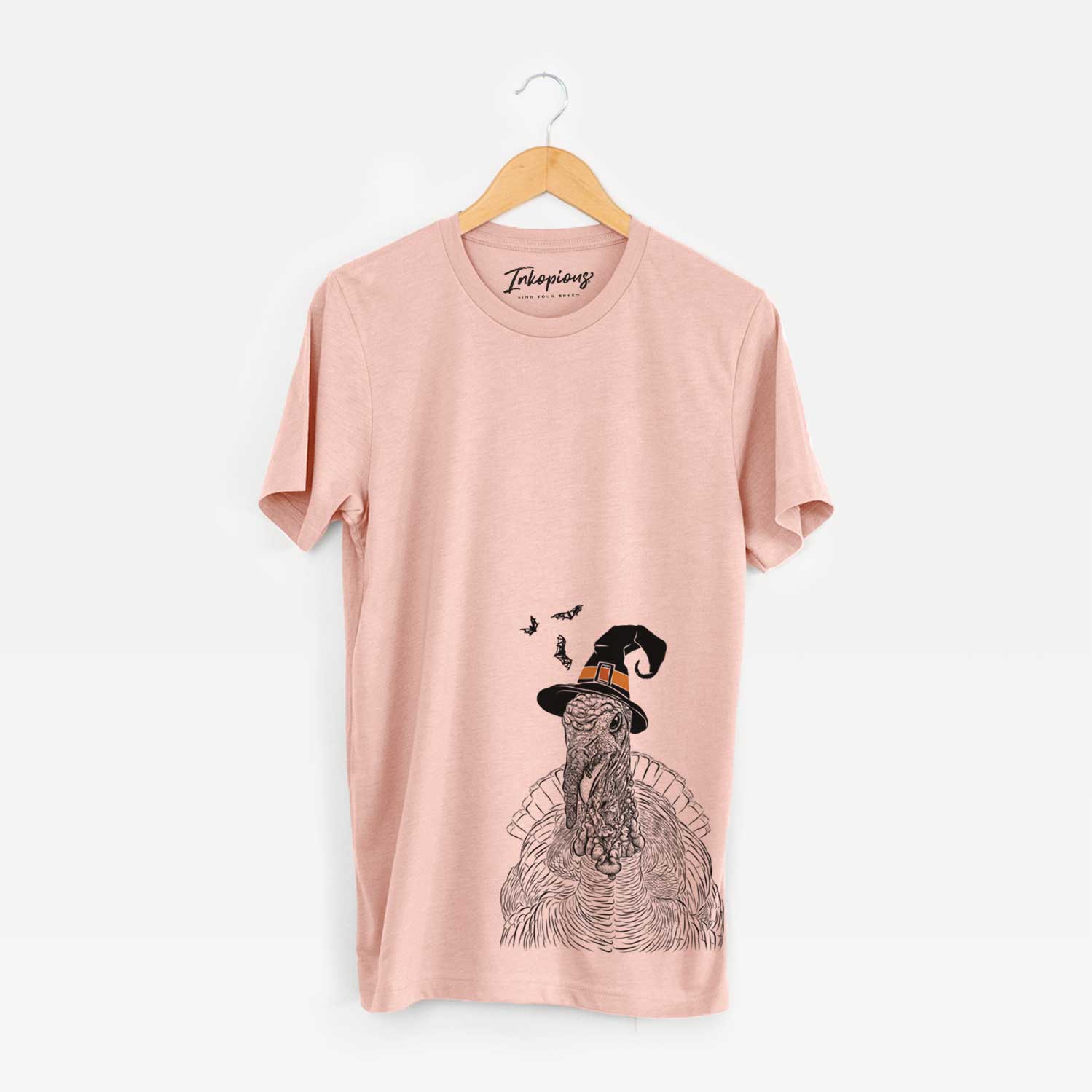 Hand-drawn sketch of Brady the Turkey wearing a witch hat on a Peach Unisex crewneck