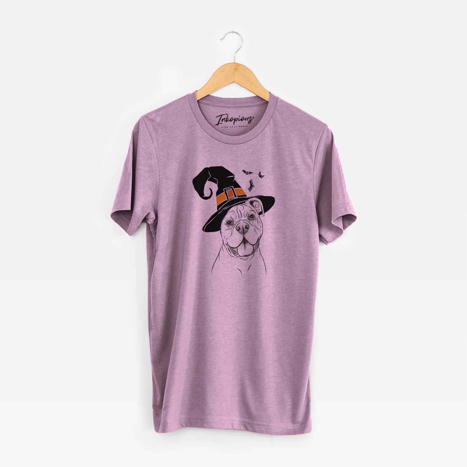 Hand-drawn sketch of Bravo the Bulldog Mix wearing a witch hat on an Orchid Unisex crewneck