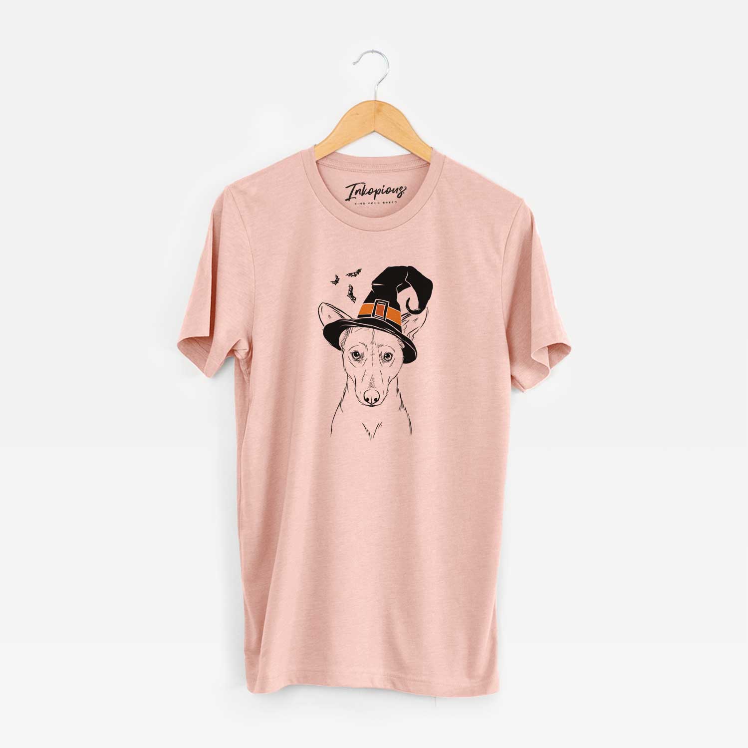 Hand-drawn sketch of Buff the Dorgi wearing a witch hat on a Peach Unisex crewneck