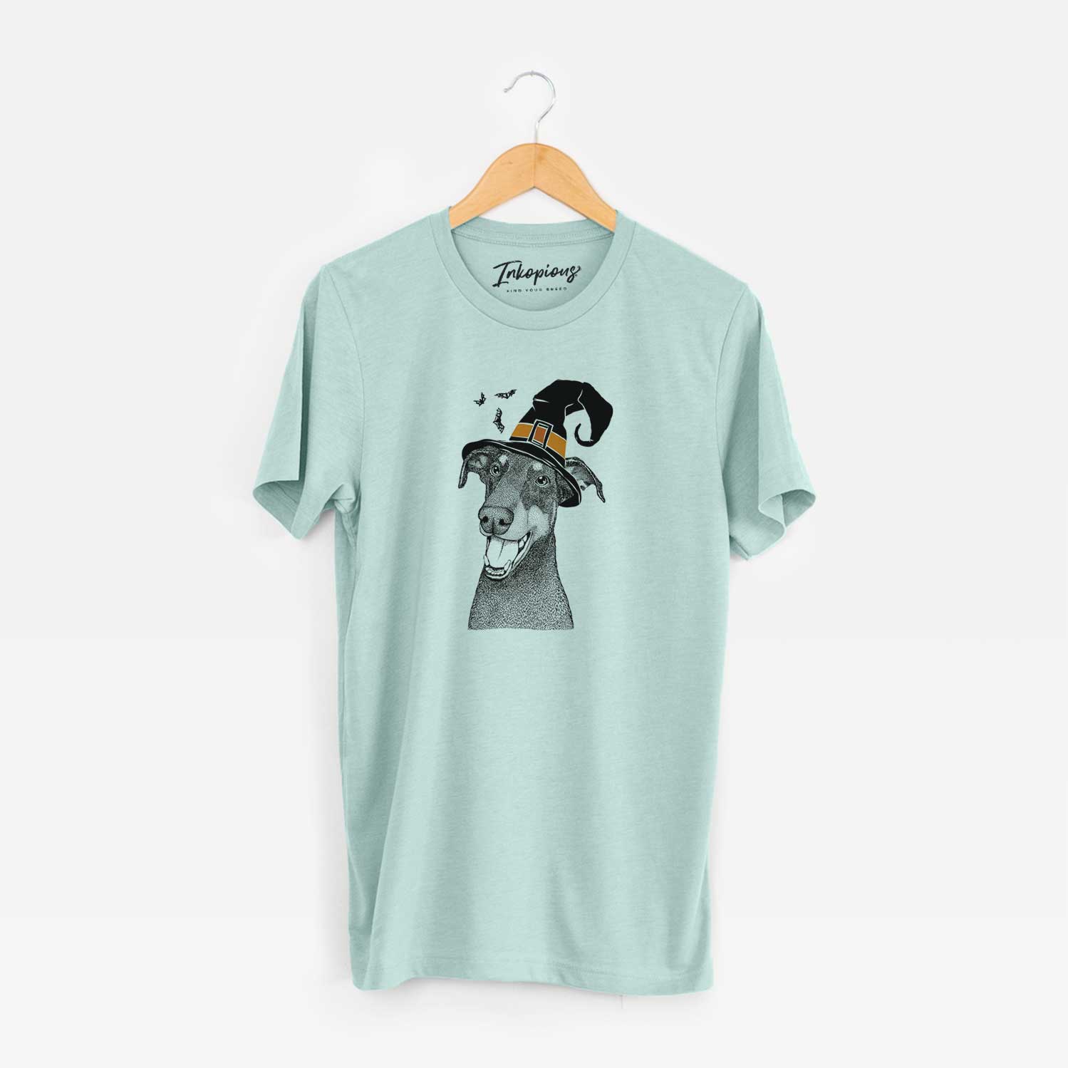 Hand-drawn sketch of Bunnie the Doberman Pinscher wearing a witch hat on a Heather Sage Unisex crewneck