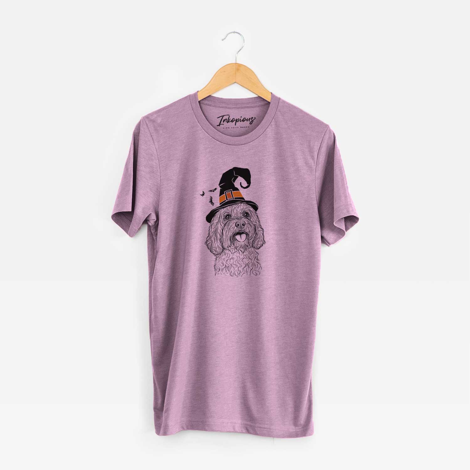 Hand-drawn sketch of Cali the Cavapoo wearing a witch hat on an Orchid Unisex crewneck