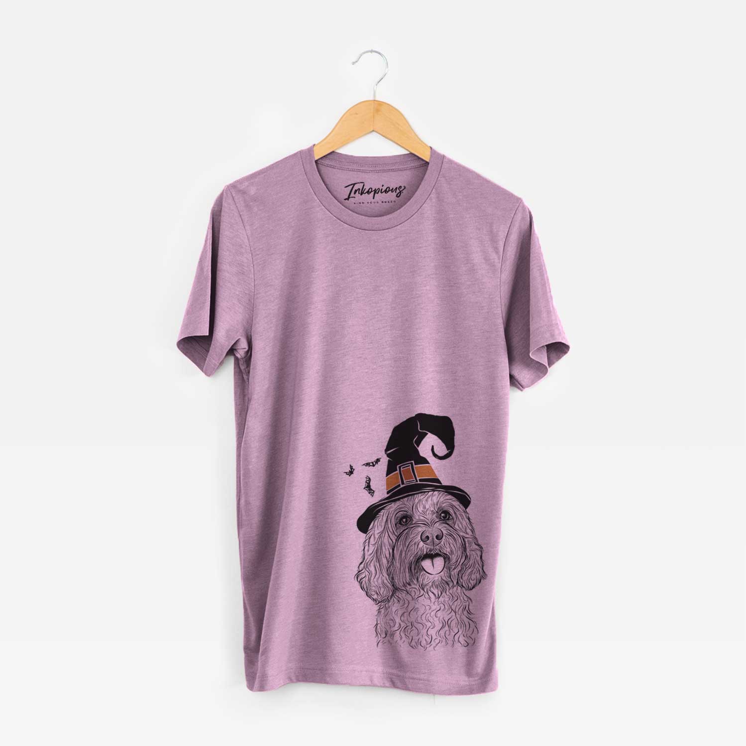 Hand-drawn sketch of Cali the Cavapoo wearing a witch hat on an Orchid Unisex crewneck