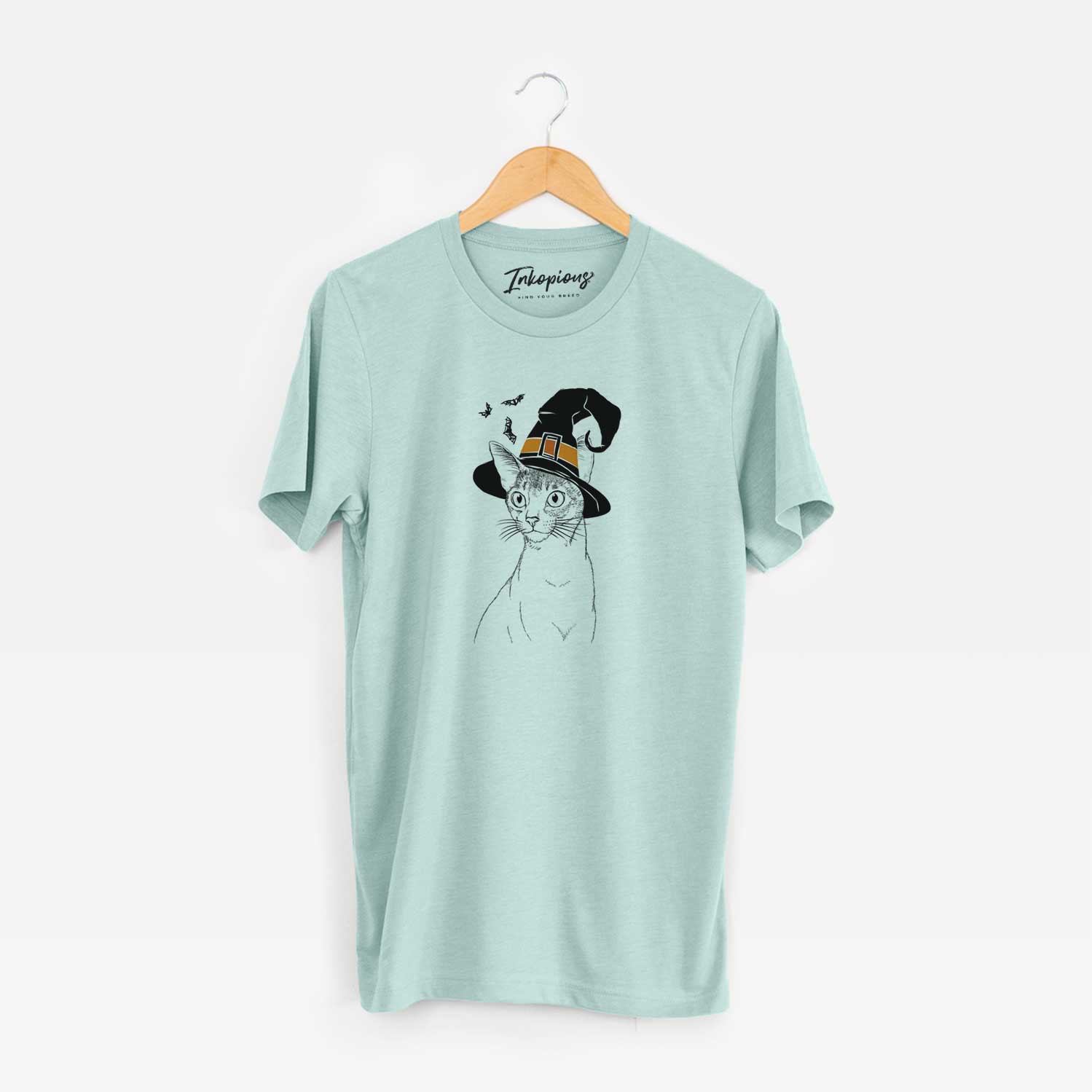 Hand-drawn sketch of Cedric the Abyssinian Cat wearing a witch hat on a Heather Sage Unisex crewneck