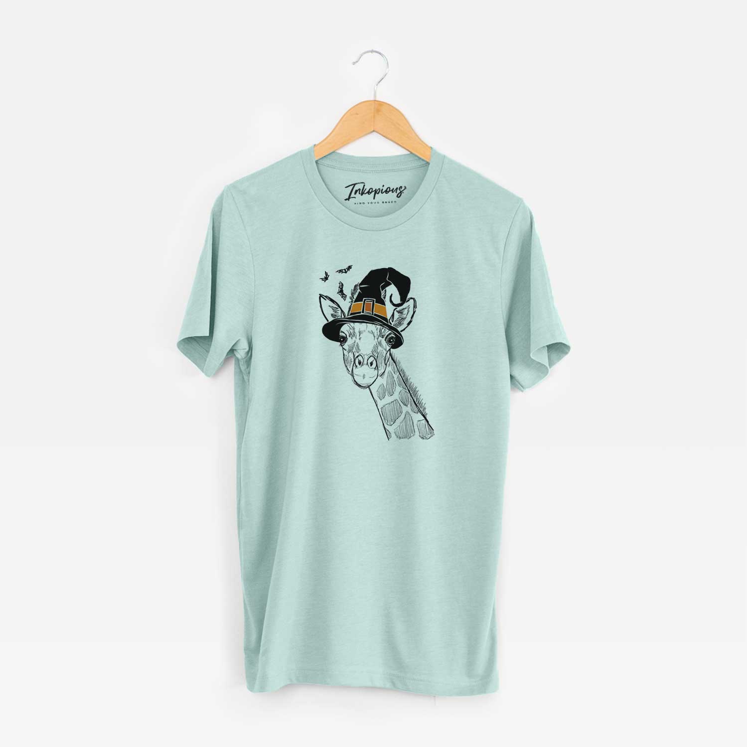 Hand-drawn sketch of Cedrick the Giraffe wearing a witch hat on a Heather Sage Unisex crewneck