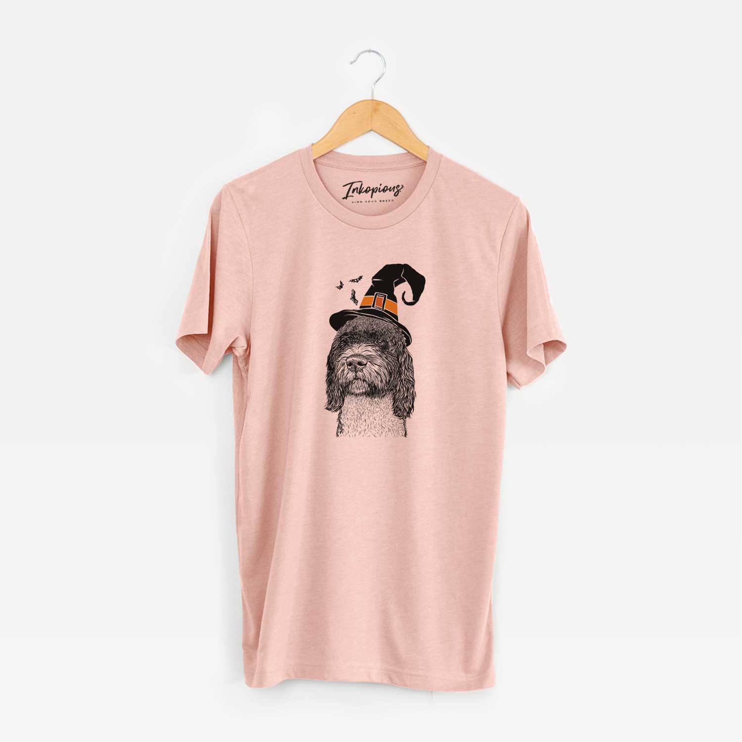 Hand-drawn sketch of Chris the Portuguese Water Dog wearing a witch hat on a Peach Unisex crewneck