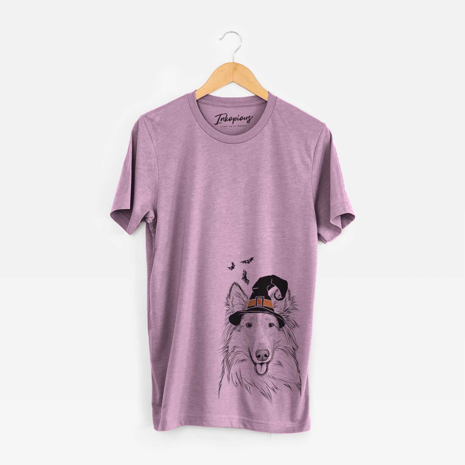 Hand-drawn sketch of Conrad the Rough Collie wearing a witch hat on an Orchid Unisex crewneck