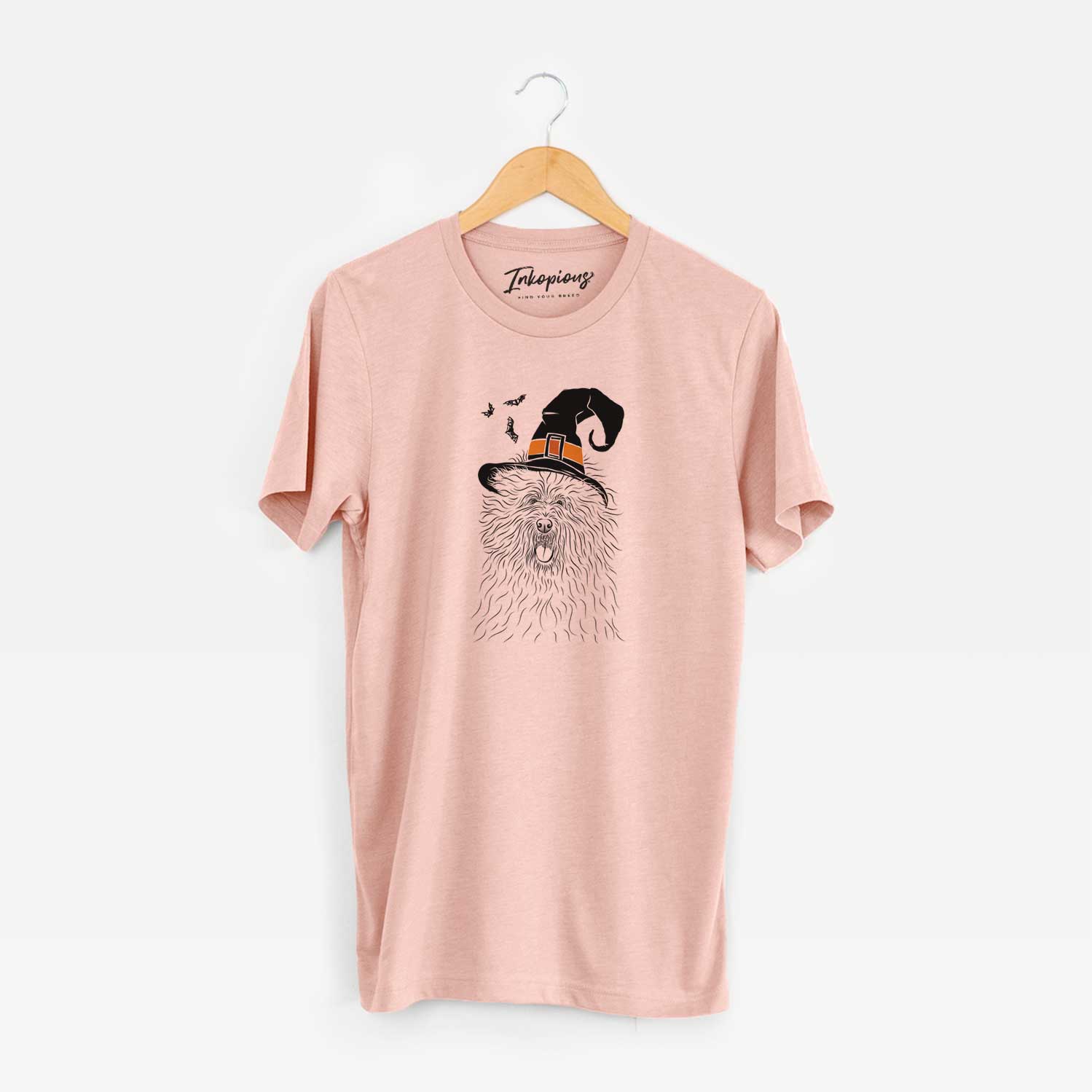 Hand-drawn sketch of Cozie the Old English Sheepdog wearing a witch hat on a Peach Unisex crewneck