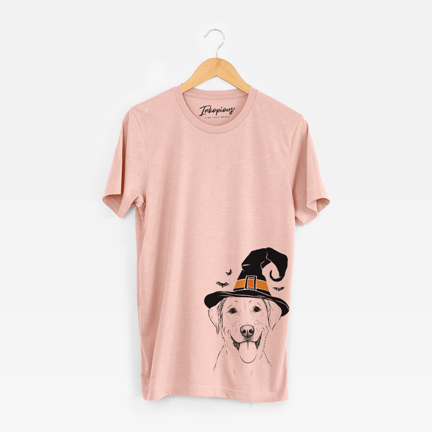 Hand-drawn sketch of Daisy the Labrador Retriever wearing a witch hat on a Peach Unisex crewneck