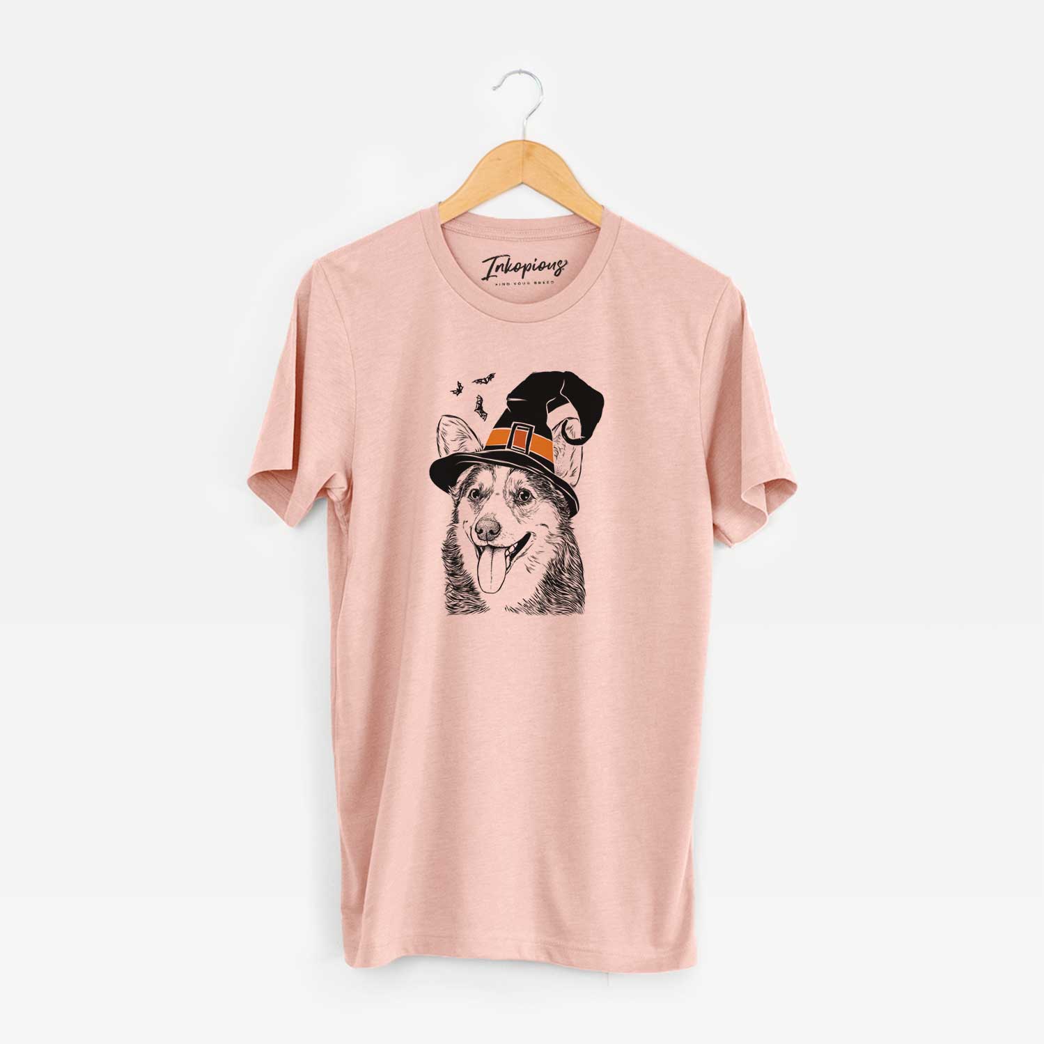 Hand-drawn sketch of Darma the Corgi wearing a witch hat on a Peach Unisex crewneck