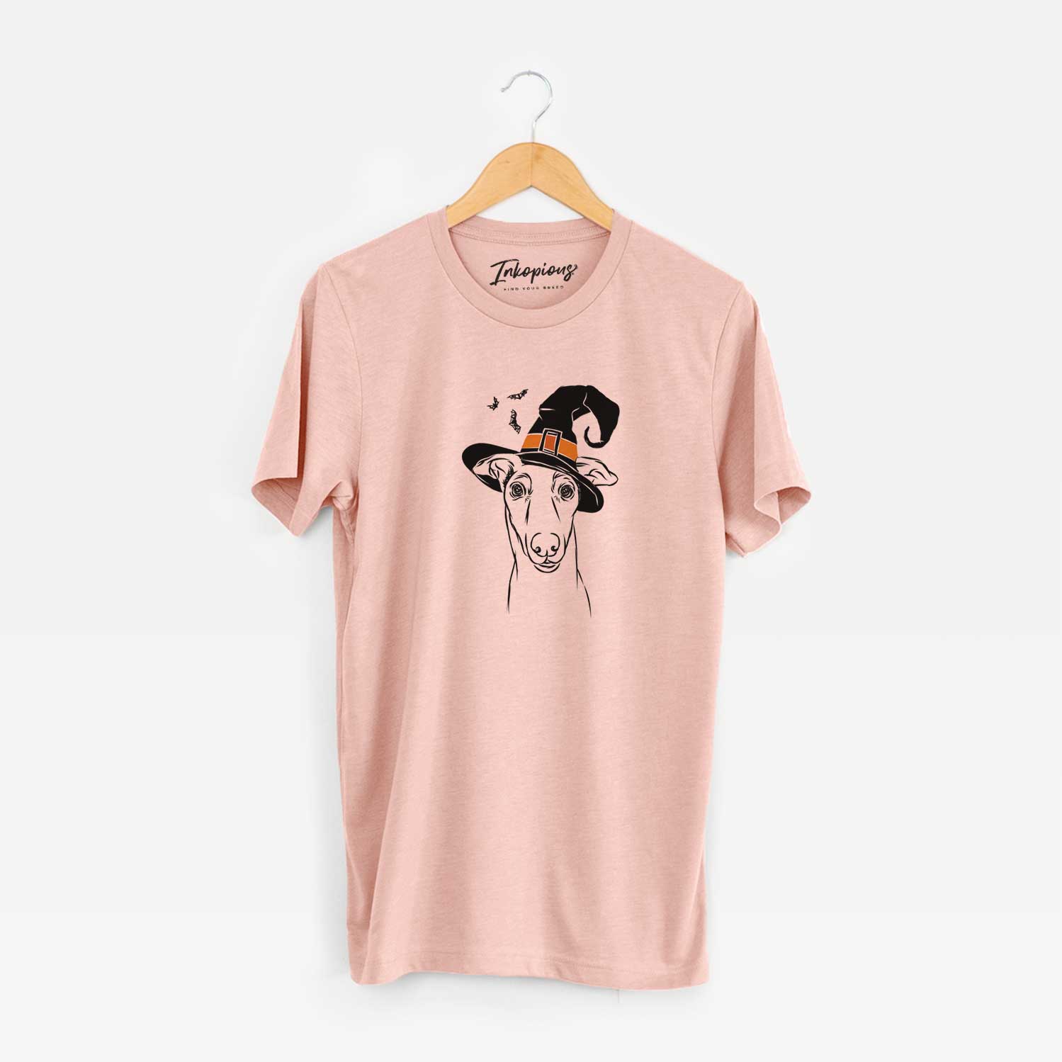 Hand-drawn sketch of Diva the Greyhound wearing a witch hat on a Peach Unisex crewneck