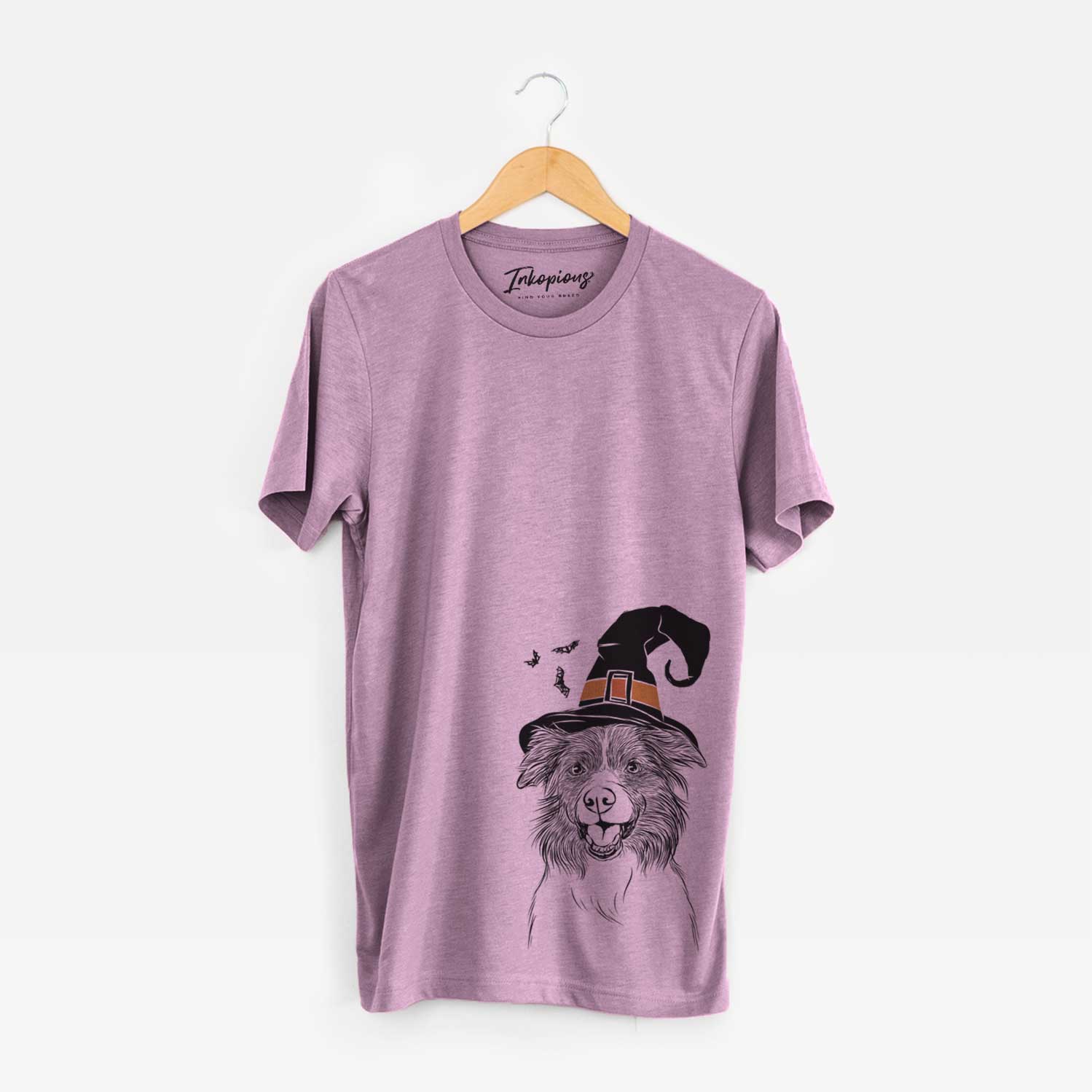 Hand-drawn sketch of Dizzy the Border Collie wearing a witch hat on an Orchid Unisex crewneck