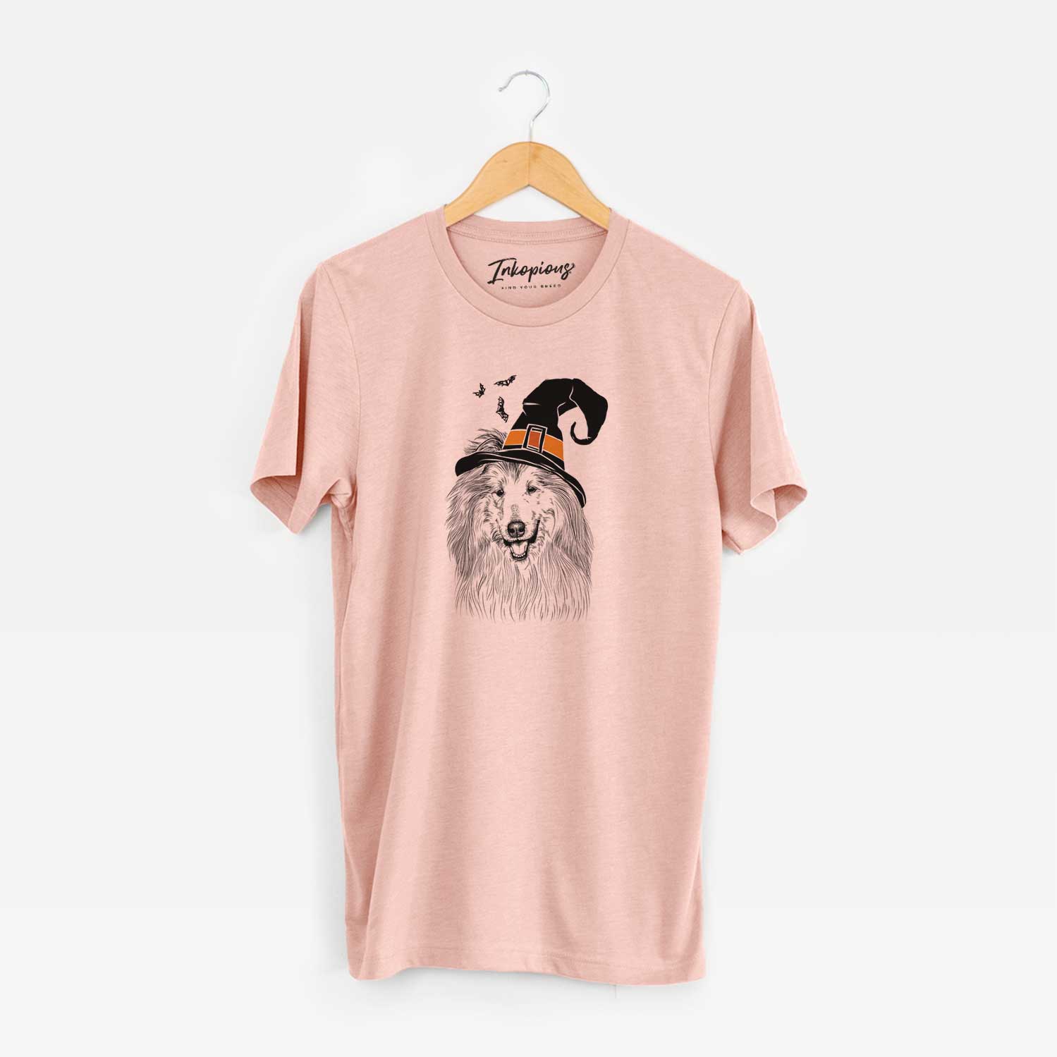 Hand-drawn sketch of Donnan the Rough Collie wearing a witch hat on a Peach Unisex crewneck