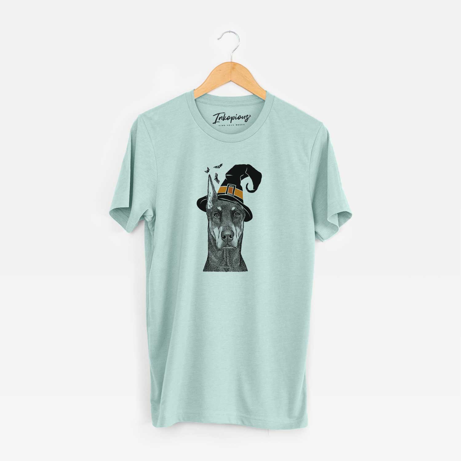 Hand-drawn sketch of Drake the Doberman Pinscher wearing a witch hat on a Heather Sage Unisex crewneck