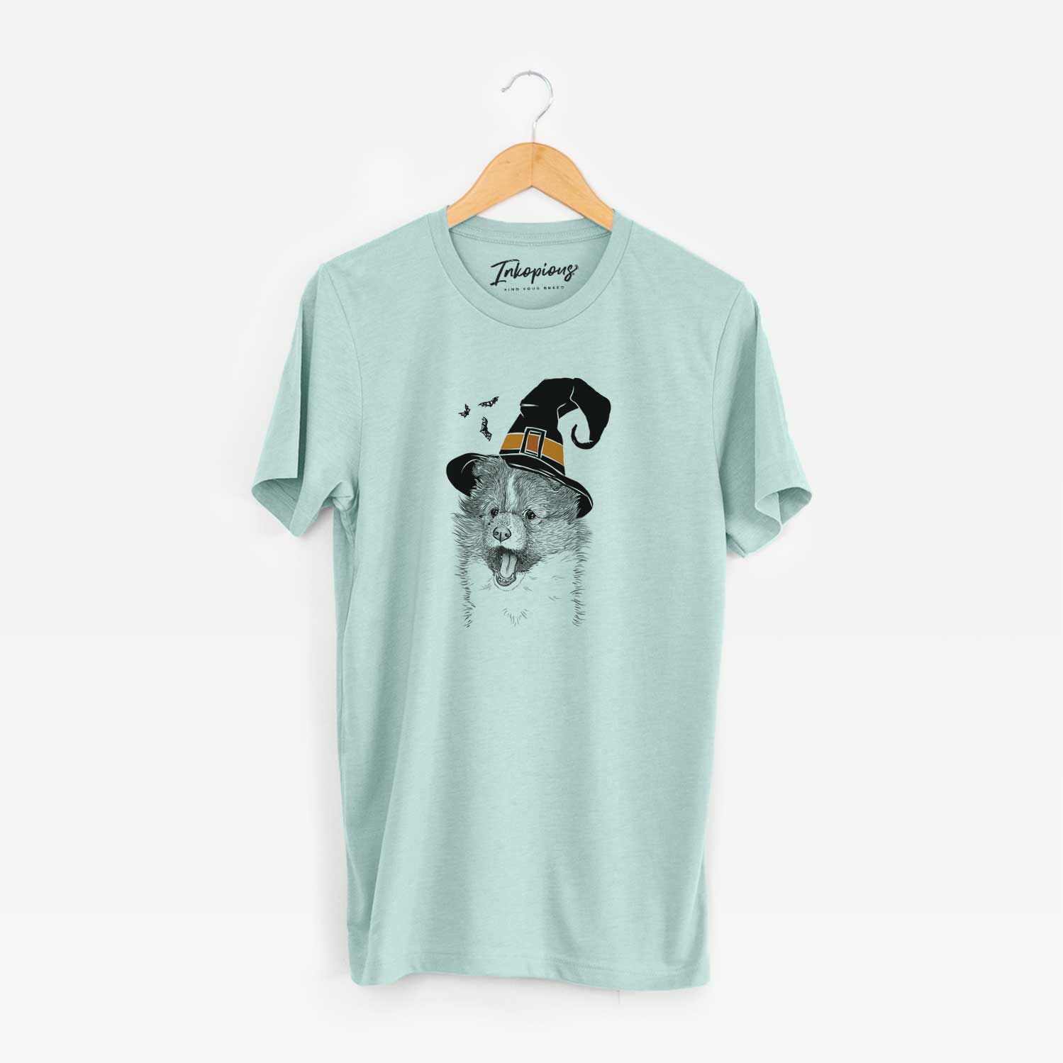 Hand-drawn sketch of Dylan the Shetland Sheepdog wearing a witch hat on a Heather Sage Unisex crewneck