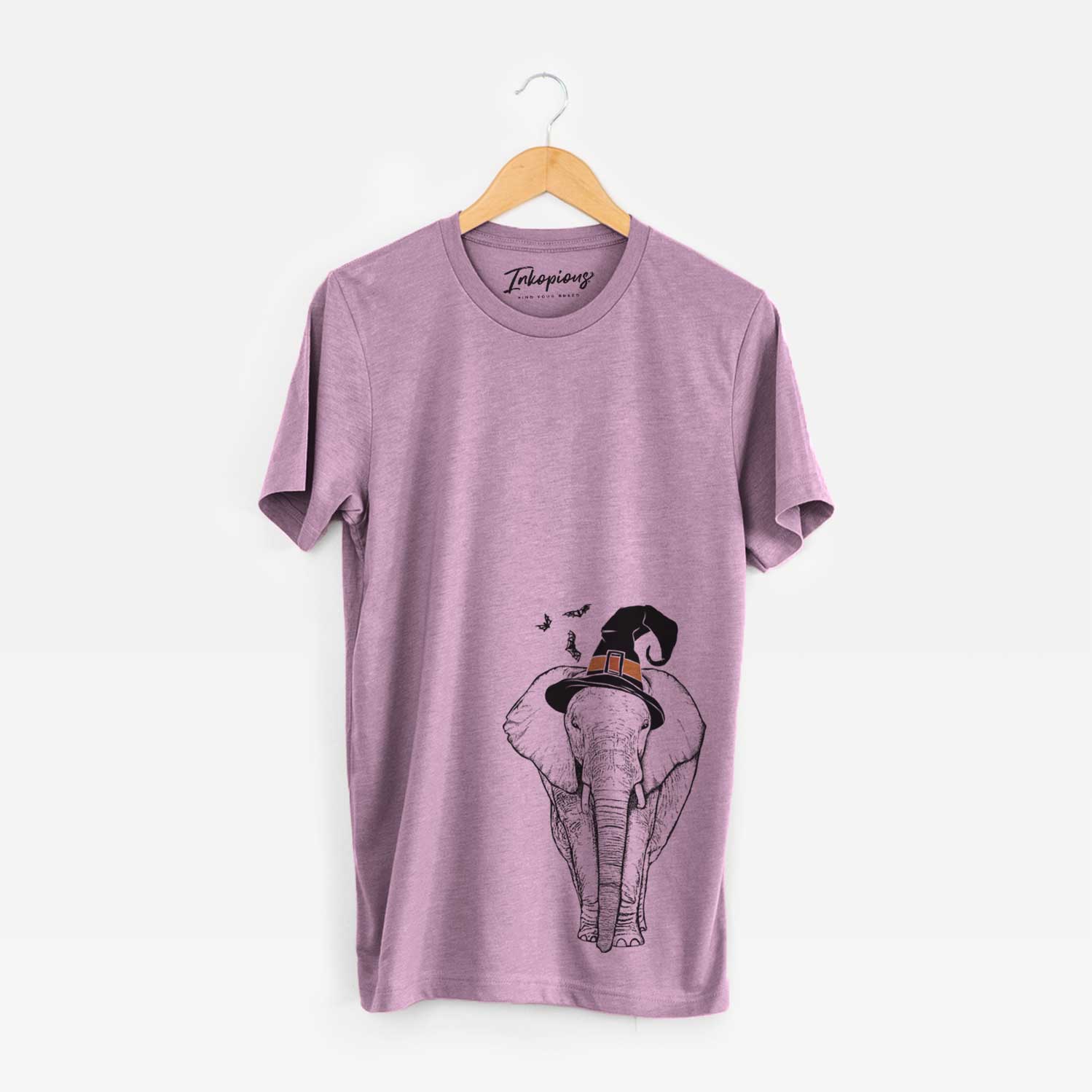 Hand-drawn sketch of Ella the Elephant wearing a witch hat on an Orchid Unisex crewneck