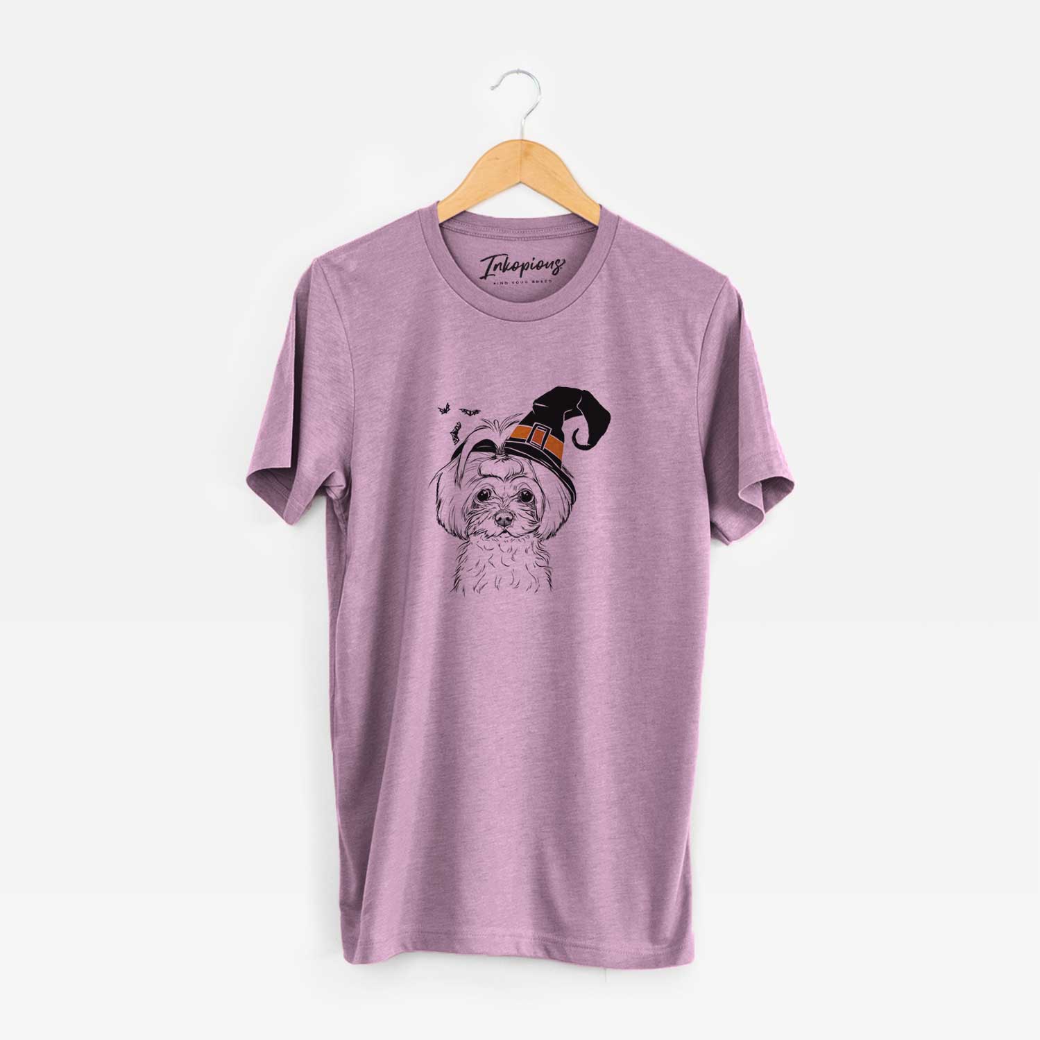 Hand-drawn sketch of Ellie the Maltese wearing a witch hat on an Orchid Unisex crewneck