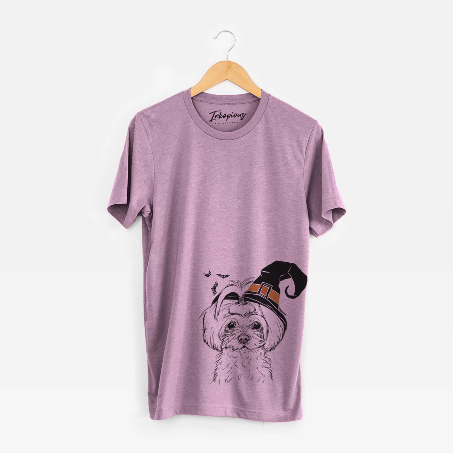Hand-drawn sketch of Ellie the Maltese wearing a witch hat on an Orchid Unisex crewneck