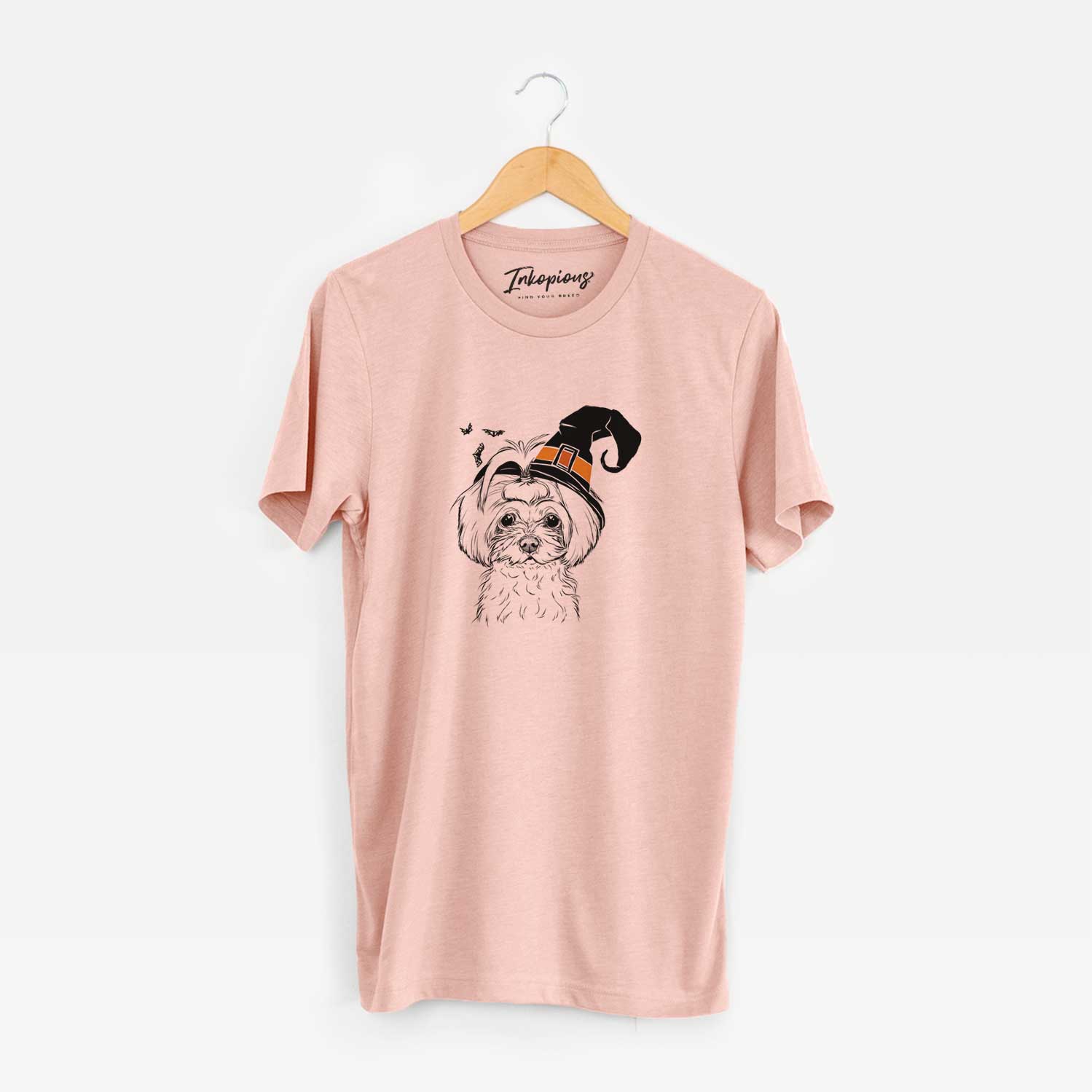 Hand-drawn sketch of Ellie the Maltese wearing a witch hat on a Peach Unisex crewneck